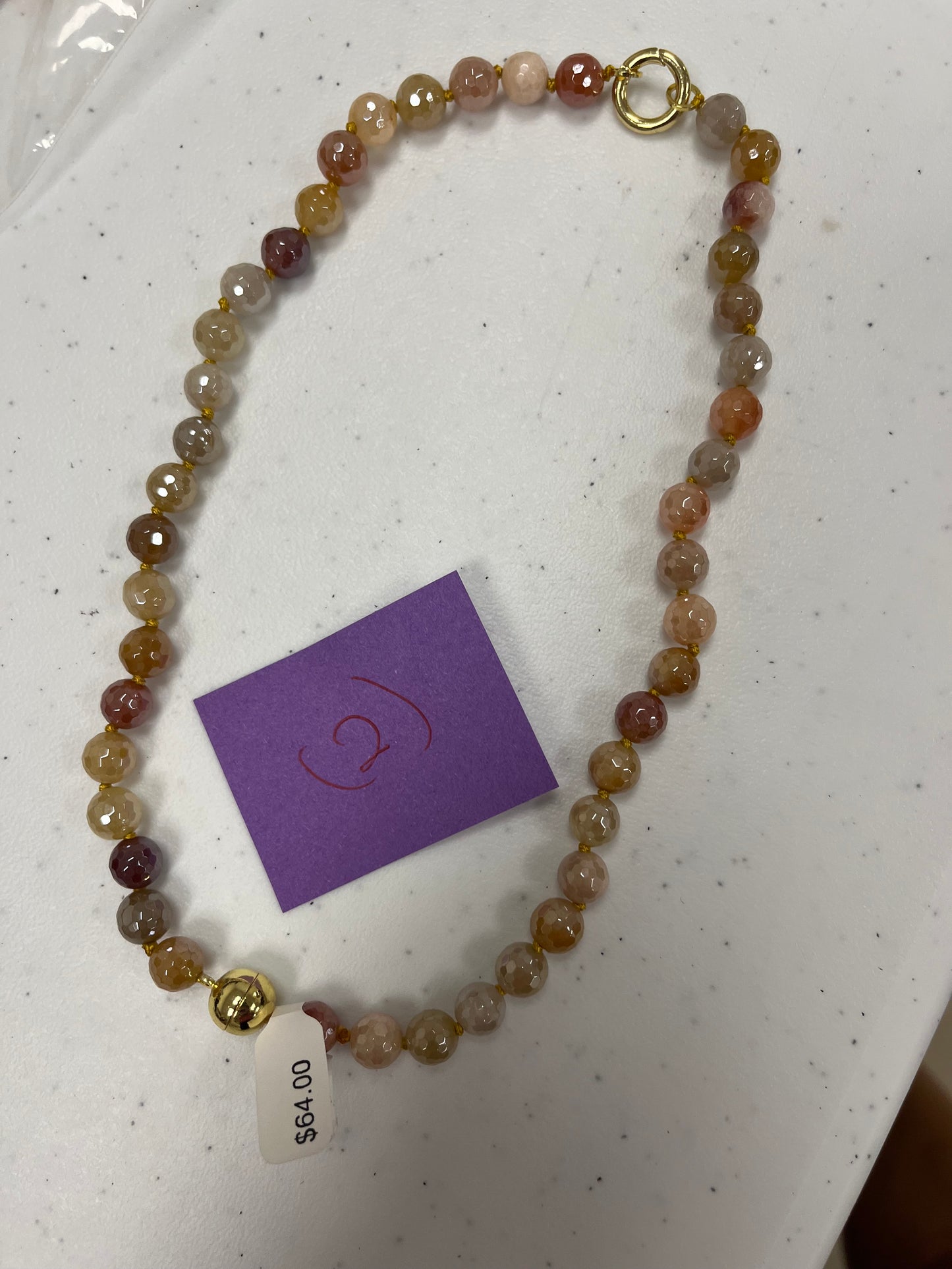 AF Designs handcrafted faceted agate bead necklace in earthy peach, gray, and burgundy tones with gold accents.