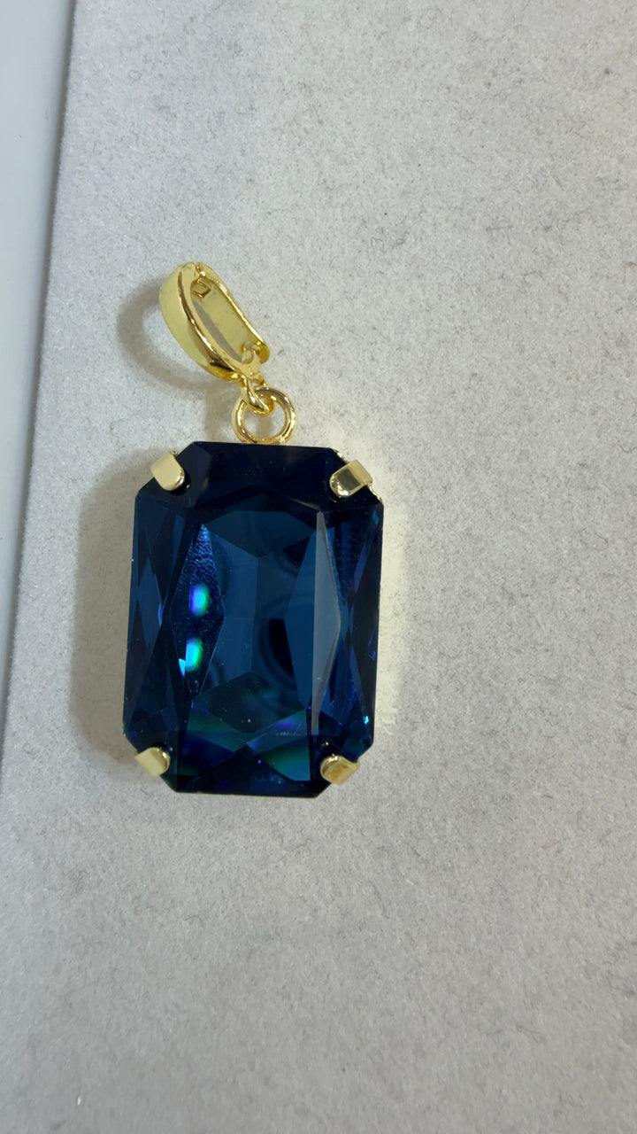 AF Designs gold-tone rectangular pendant with large faceted deep blue crystal stone in four-prong setting