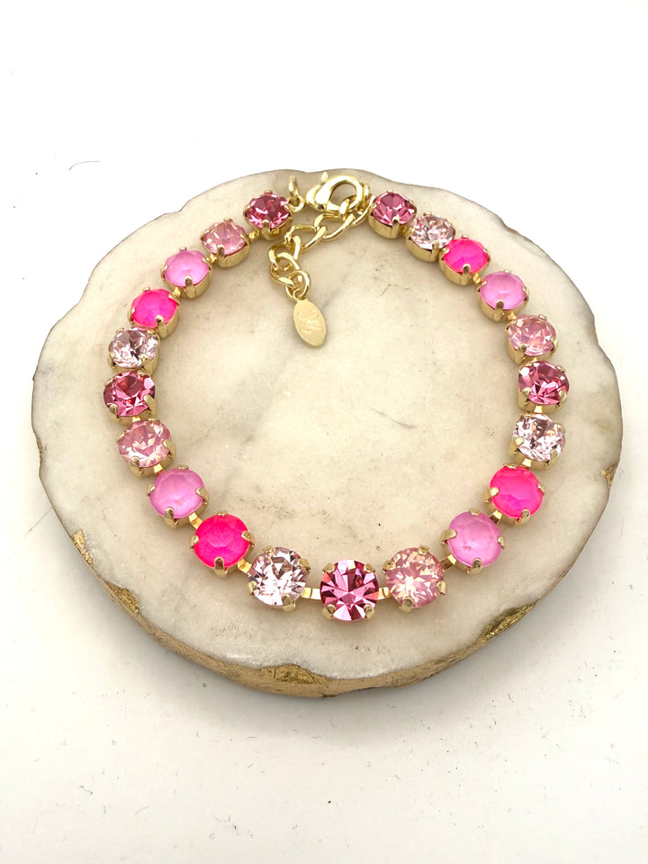 AF Designs gold tennis bracelet with mixed pink crystals in neon, blush, rose, and frosted tones with lobster clasp