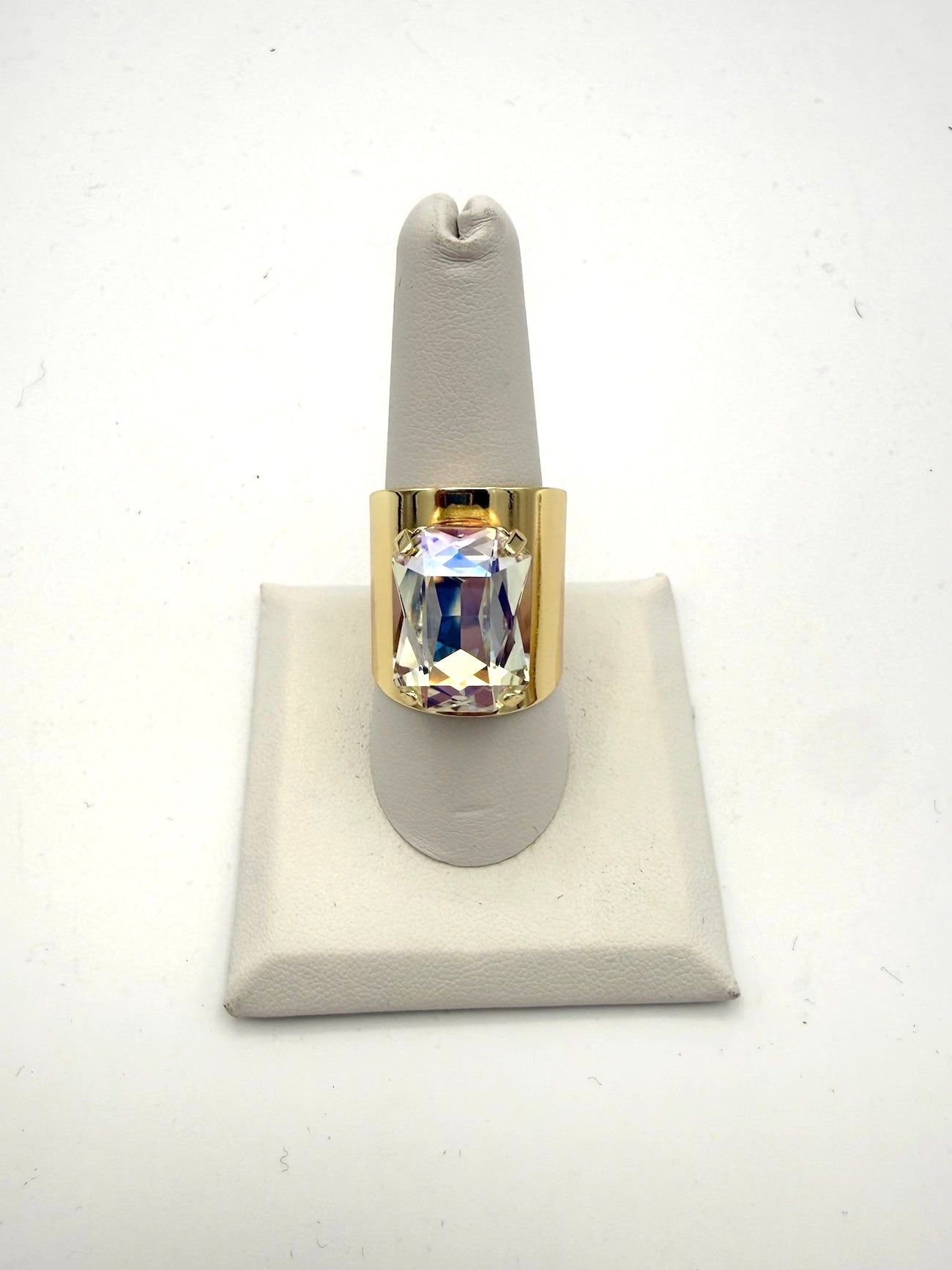 Bold gold-tone wide band ring with large iridescent AB crystal emerald-cut stone, statement cocktail style