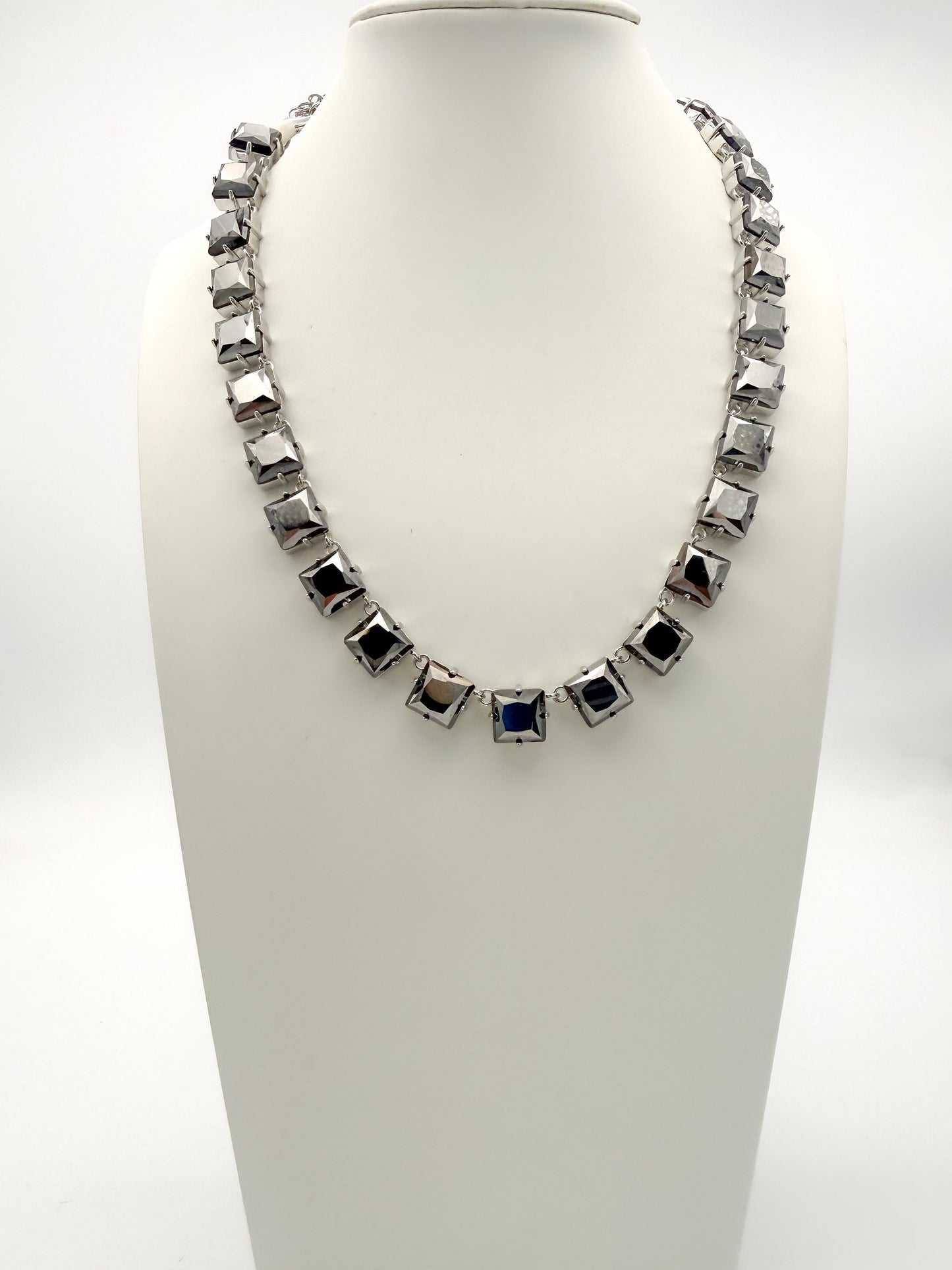 Gunmetal square-link statement collar necklace with color-shifting black and navy cushion-shaped stones.