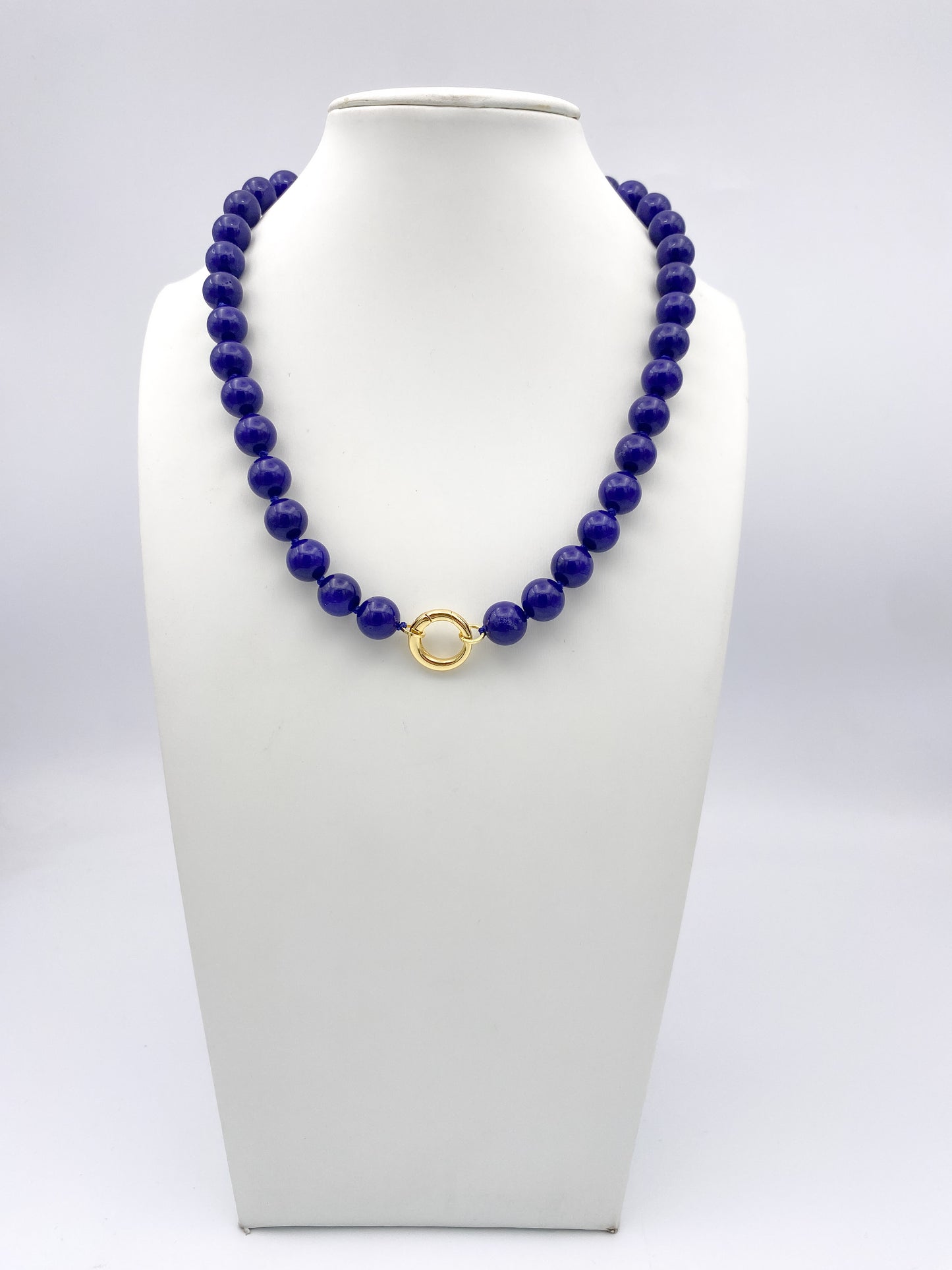 AF Designs Cobalt Dreams Necklace: polished cobalt blue beaded strand with gold circular clasp on white bust.