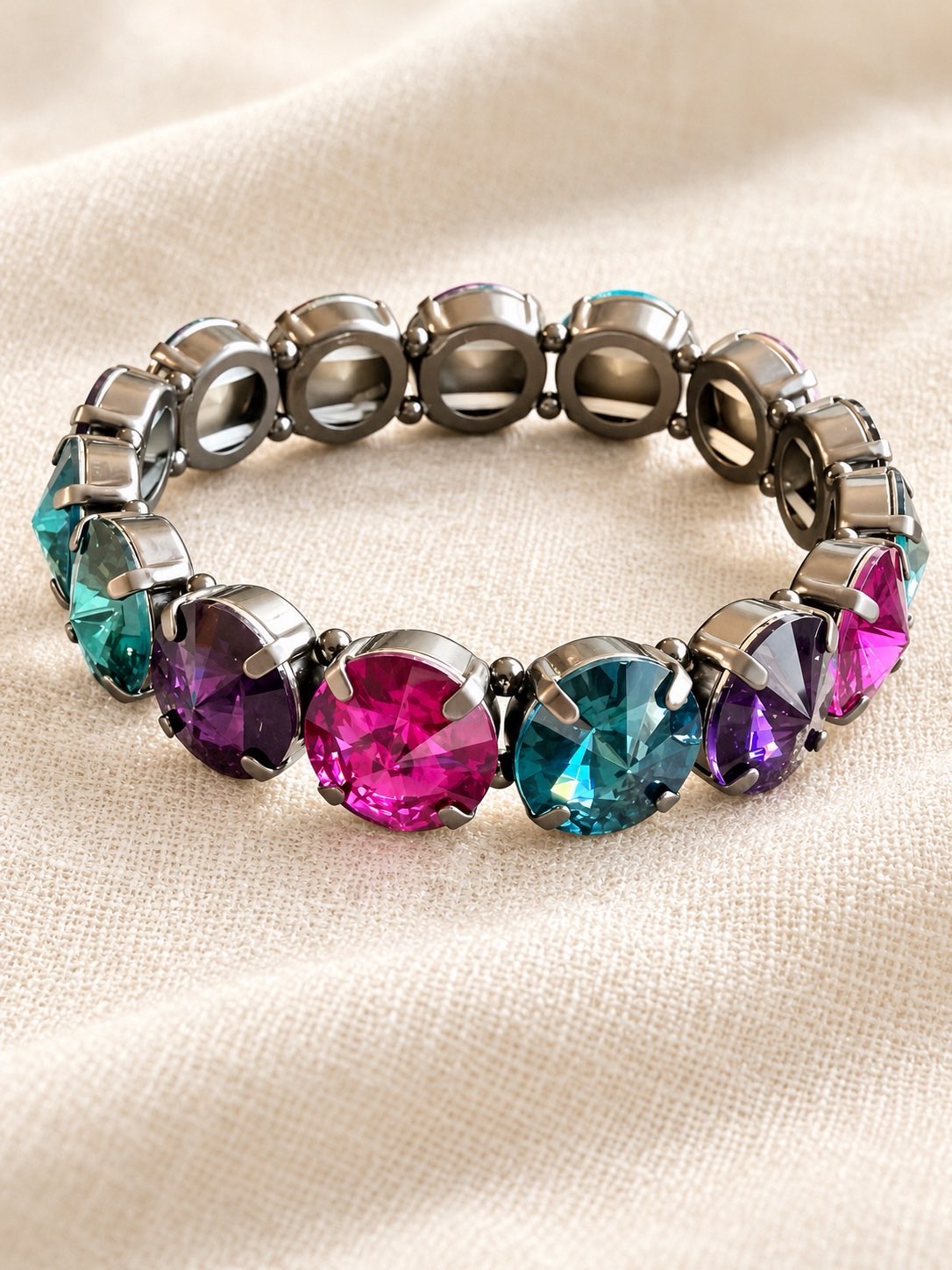 Multicolor stretch bracelet with faceted pink, teal, and purple crystals in gunmetal prong settings