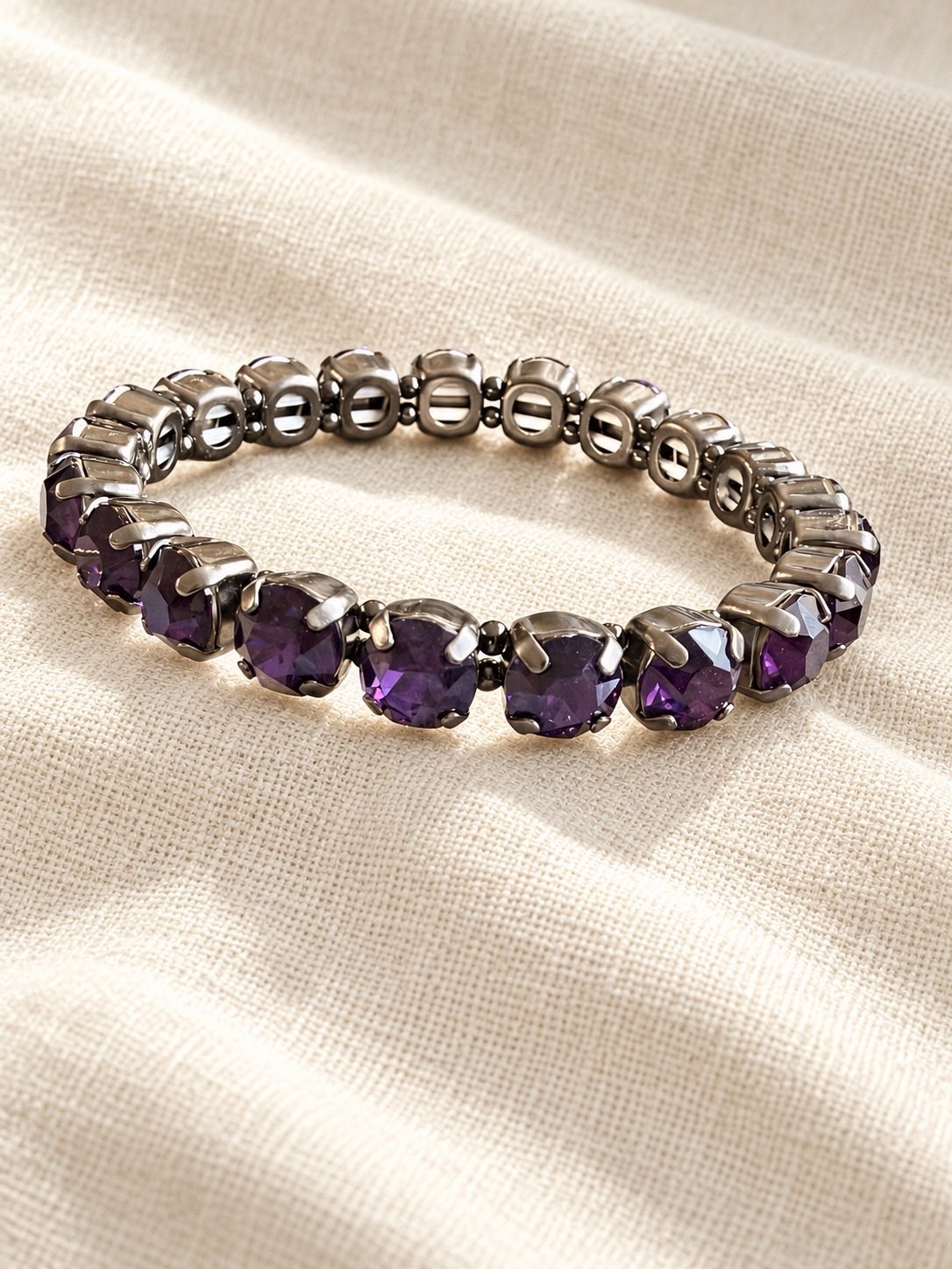 Drama Club stretch bracelet with deep purple cushion-cut crystals in dark gunmetal silver prong settings