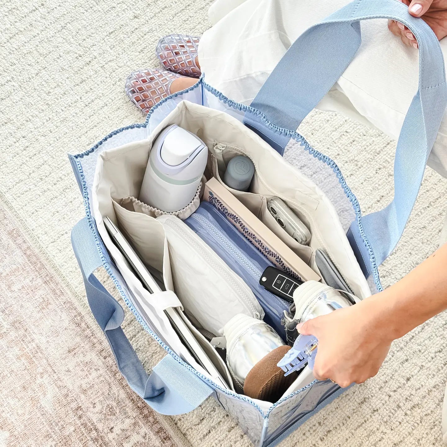 Case-Mate tote organizer insert in French Vanilla with multiple compartments holding everyday essentials inside a blue tote bag.