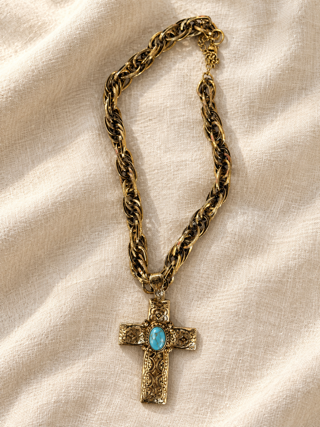 Antiqued gold chunky chain necklace with ornate engraved cross pendant and turquoise cabochon centerstone