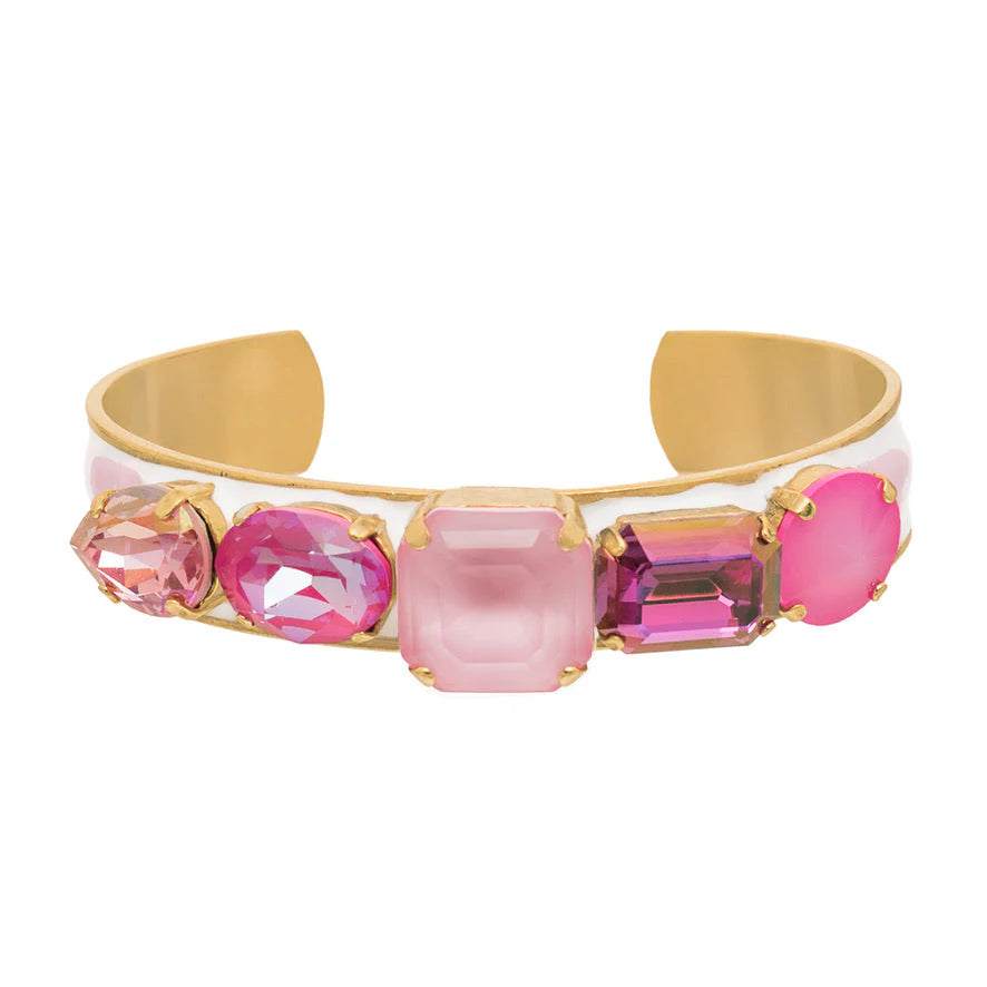 Gold cuff bracelet with five pink and purple gemstones on white enamel base