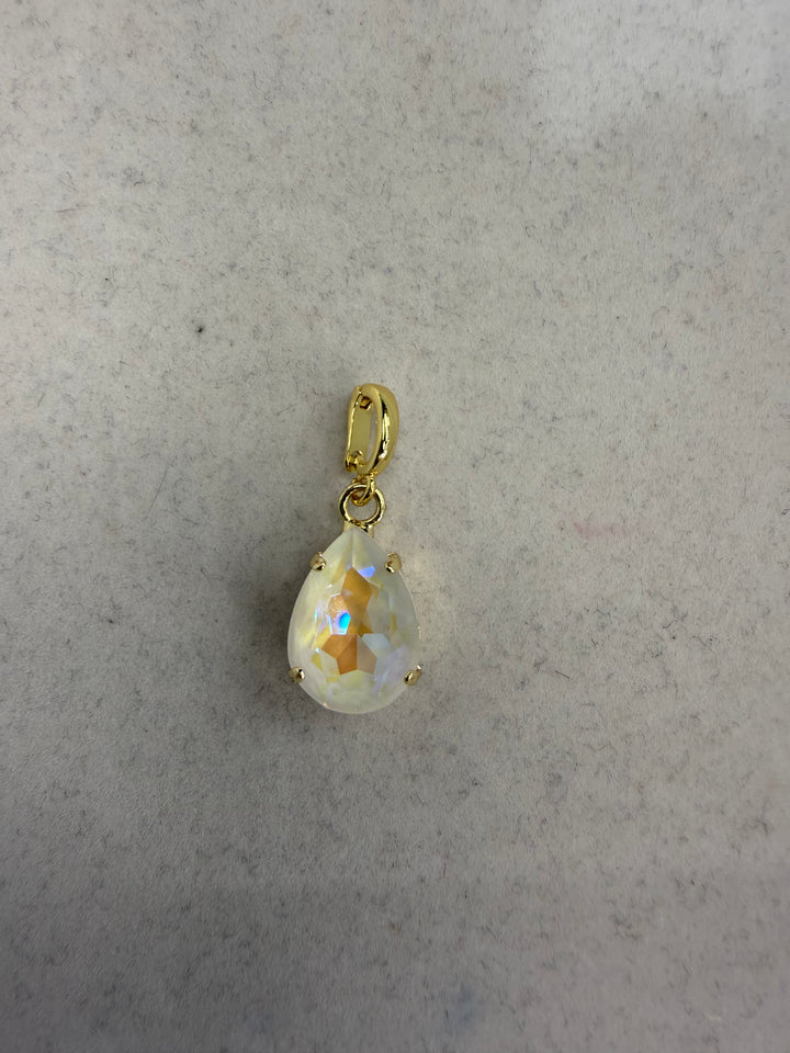 Gold teardrop charm with iridescent white AB crystal stone in prong setting with gold bail.