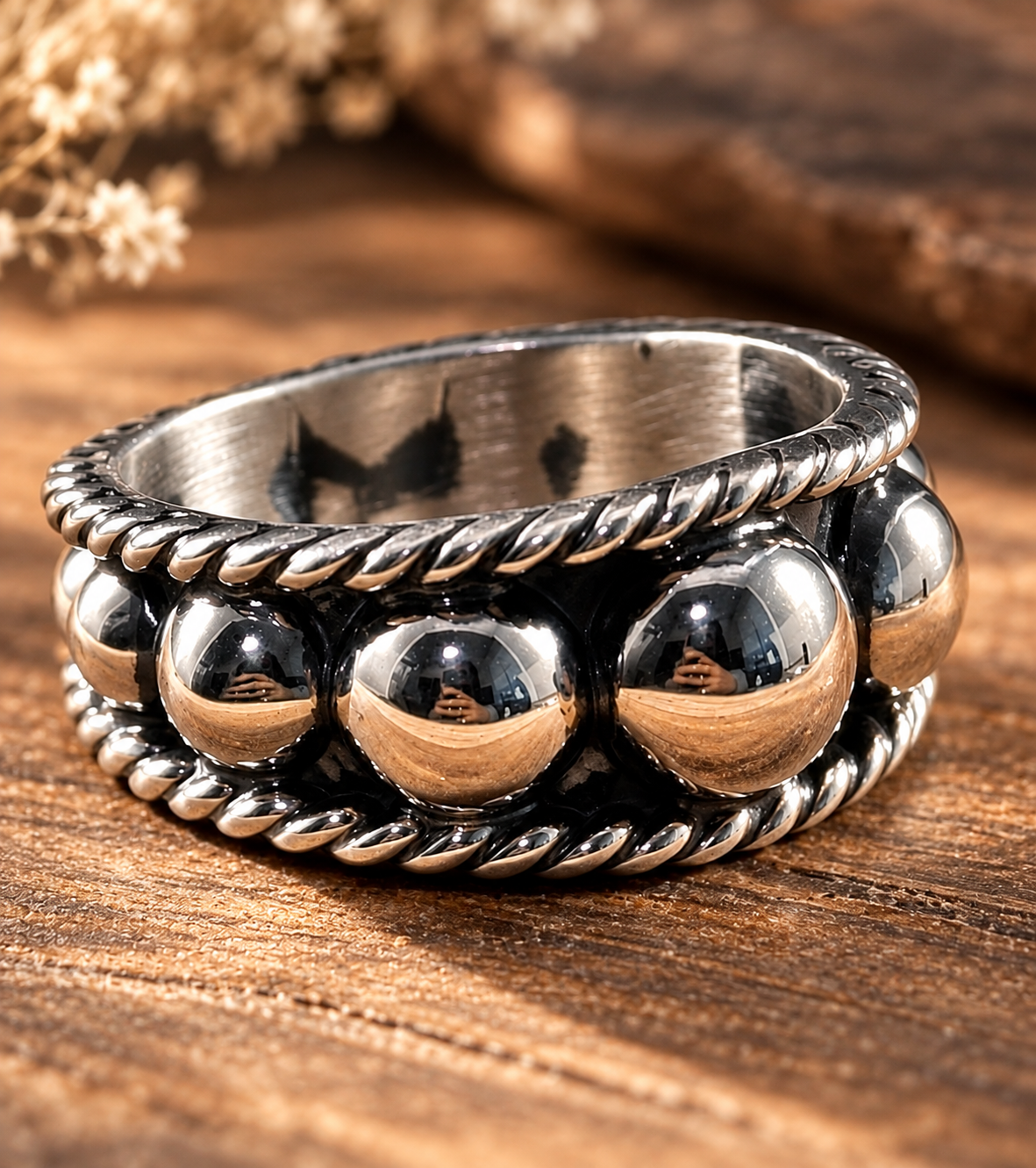 Silver Spur Ring in sterling silver with polished graduated beads between twisted rope borders on an oxidized band