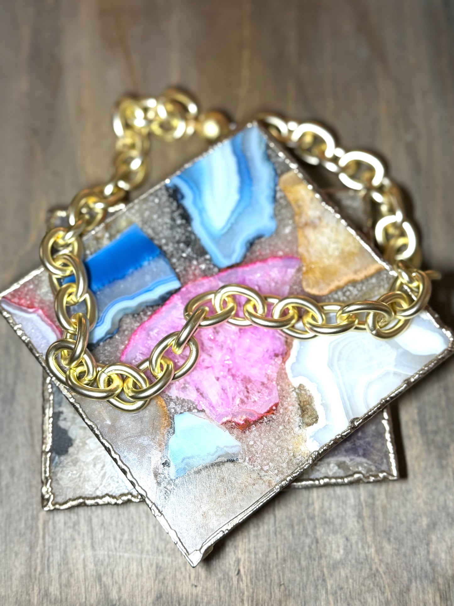 AF Designs Style Icon chunky gold chain-link statement necklace displayed on colorful agate stone tray