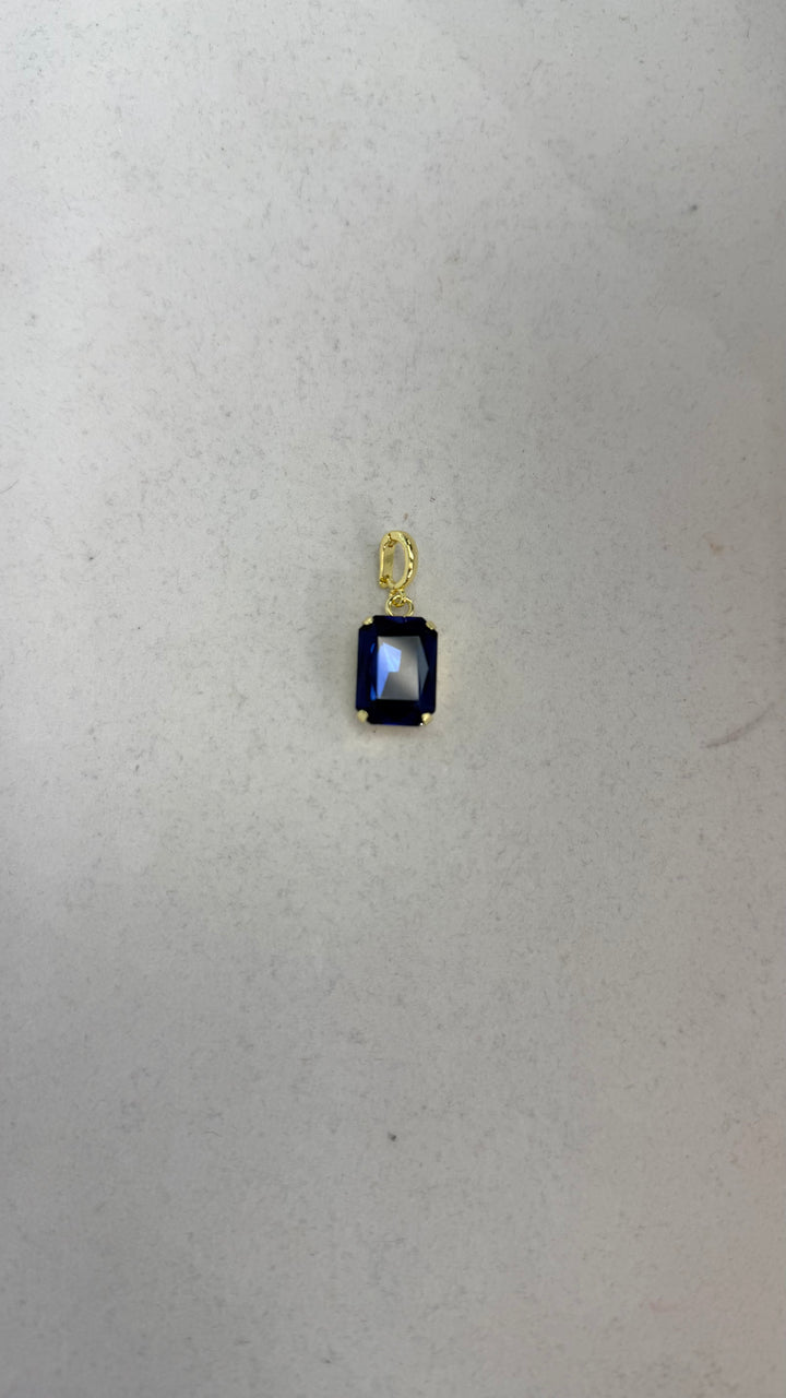 AF Designs small gold charm with emerald-cut sapphire blue crystal stone and textured oval bail clasp