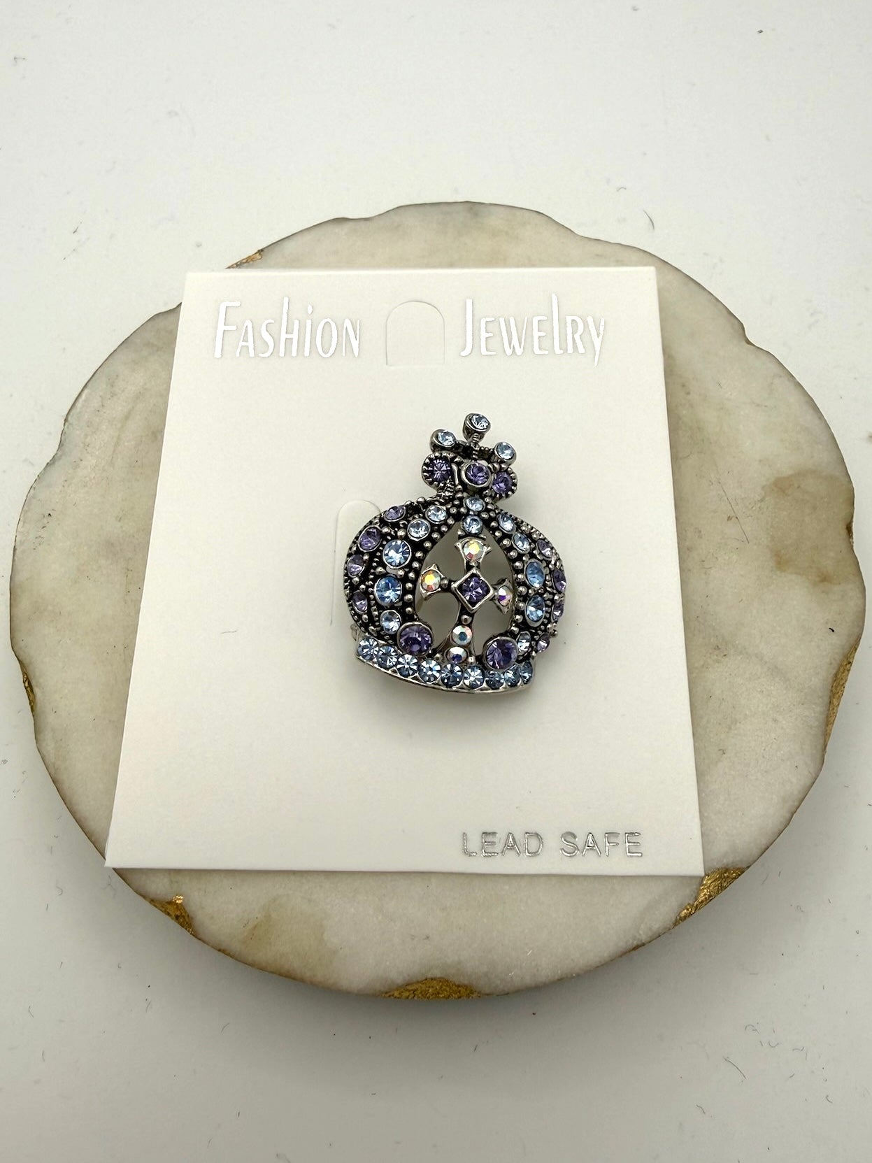 Crown brooch with blue and purple rhinestones and iridescent cross detail on gunmetal silver base