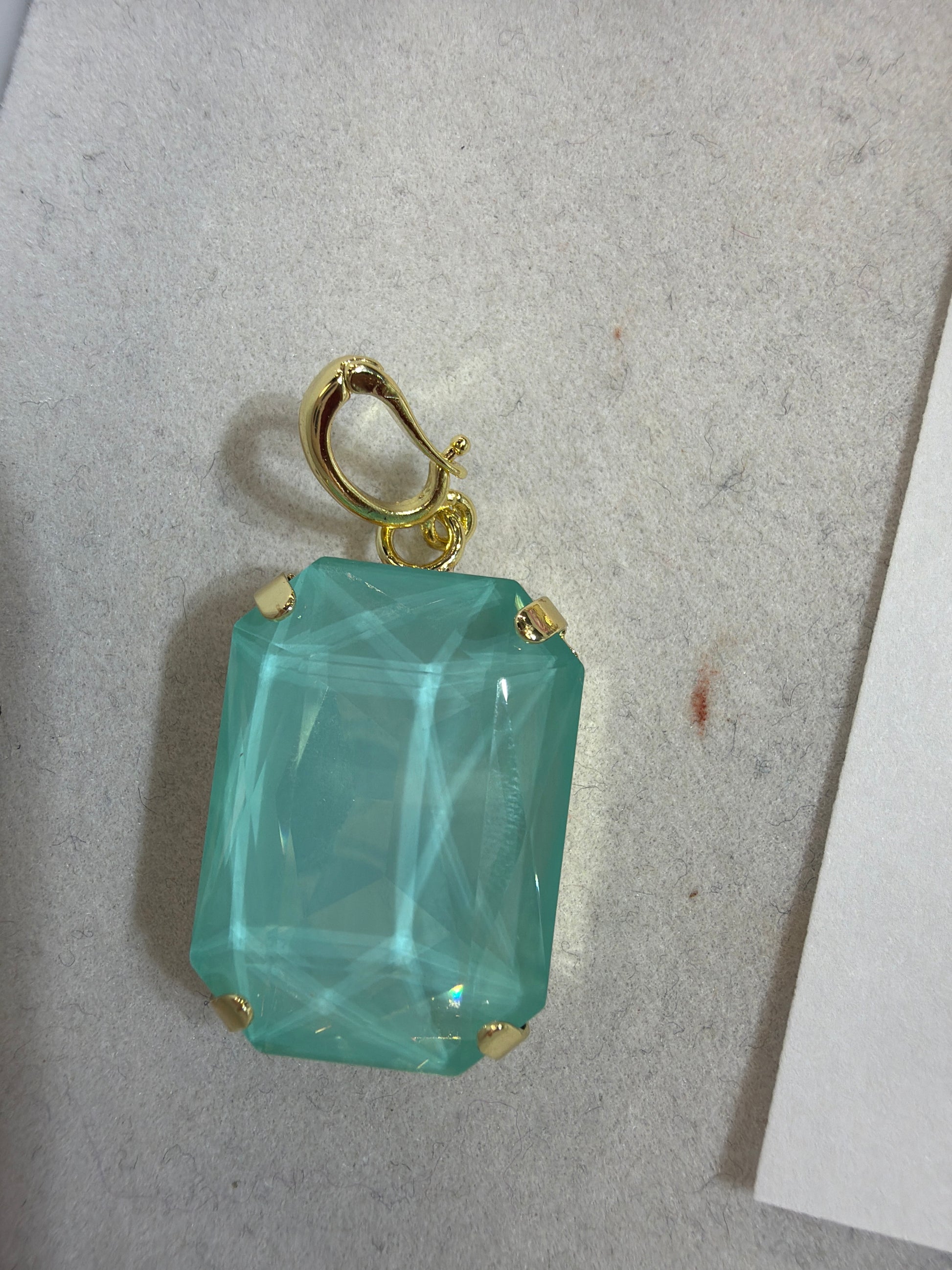 Large emerald-cut aqua mint gemstone charm pendant with gold prong settings and lobster clasp bail