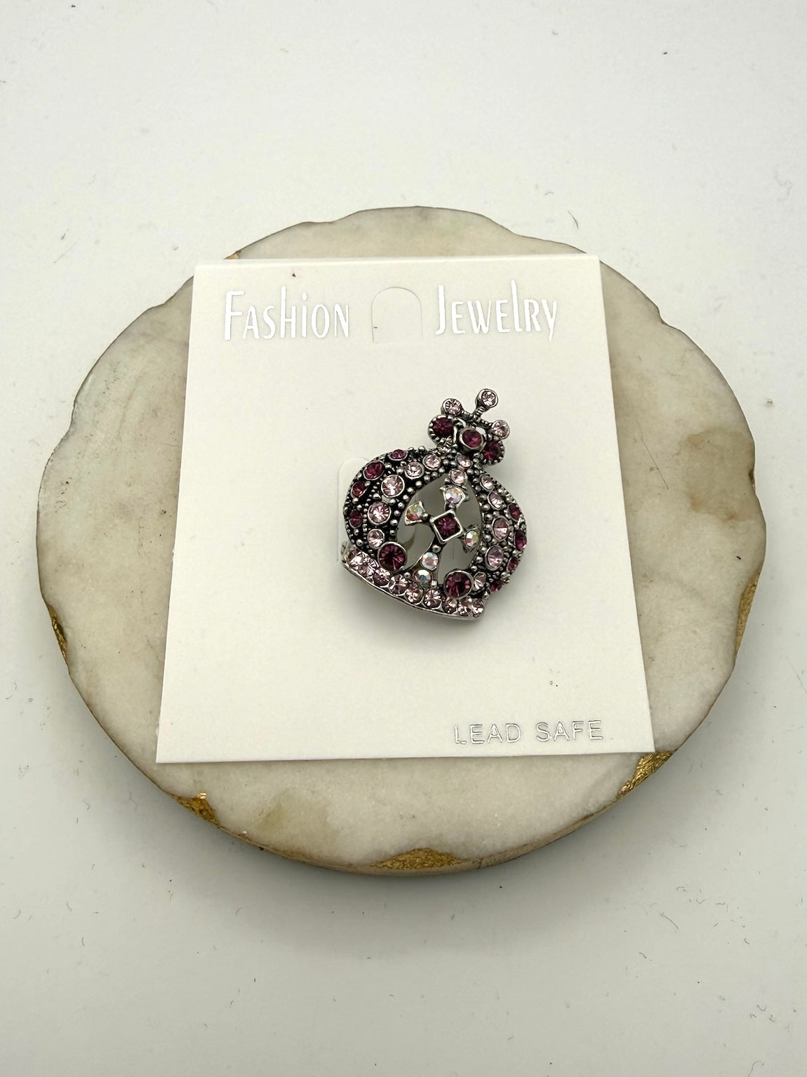 Ornate crown brooch in antiqued silver with pink and purple rhinestones, featuring filigree center and bow detail.