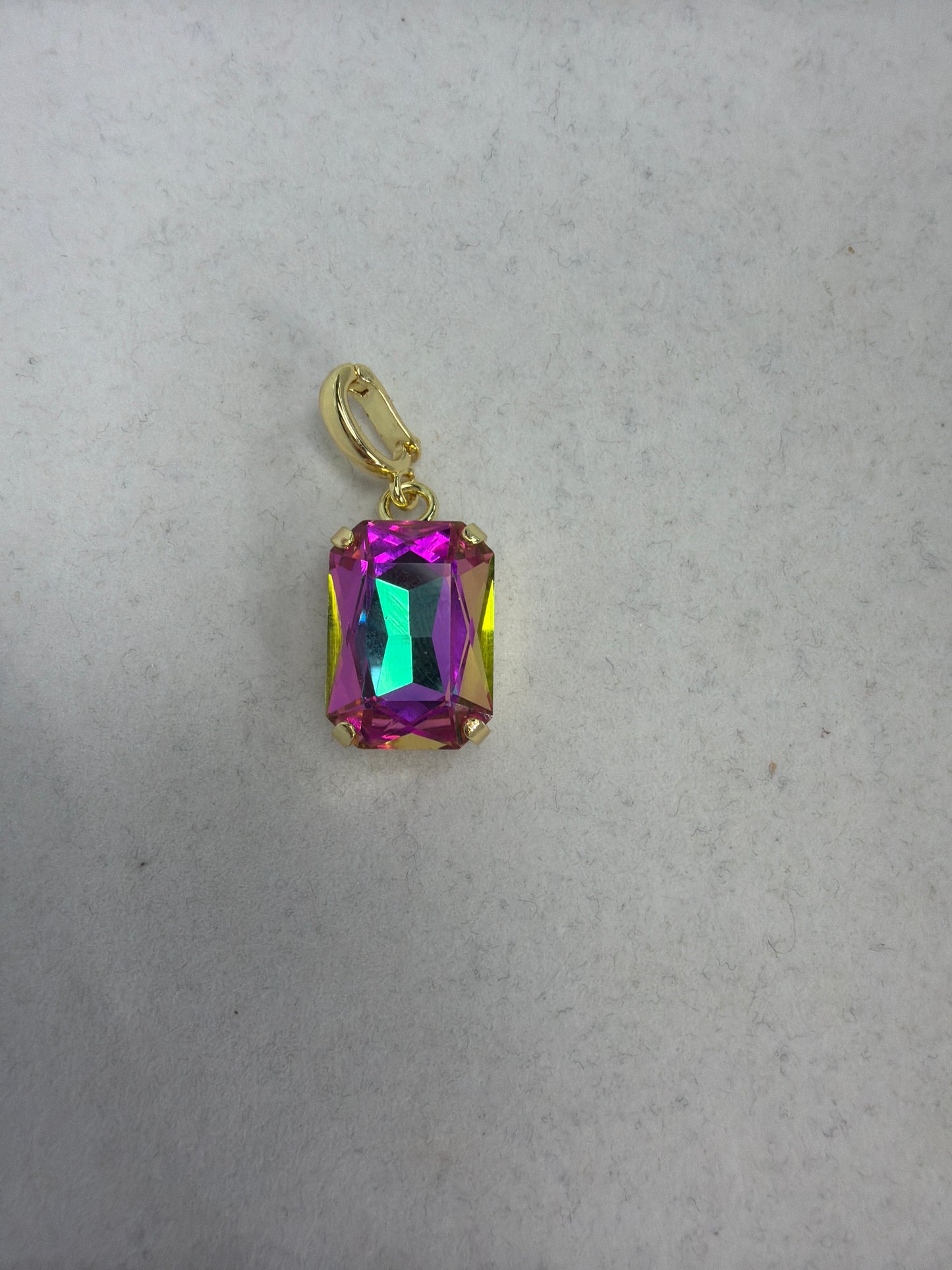 Small rectangle iridescent crystal charm in mermaid pink-teal hues with gold-tone prong setting and bail clasp