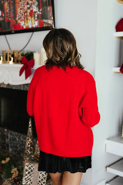 The Nutcracker Cardigan by Grace + Emma, red cable-knit Christmas cardigan with sequin nutcracker appliqués