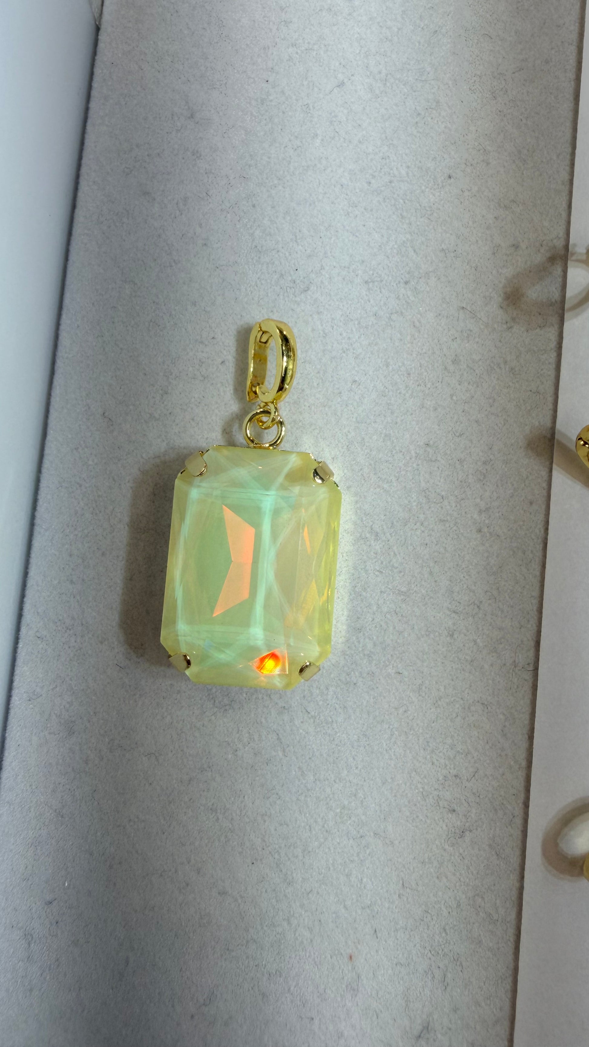 AF Designs rectangular creamy opal iridescent faceted charm pendant with gold prong setting and bail