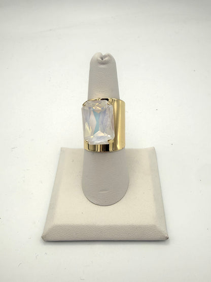Bold gold wide-band cocktail ring with large iridescent emerald-cut opalescent crystal stone