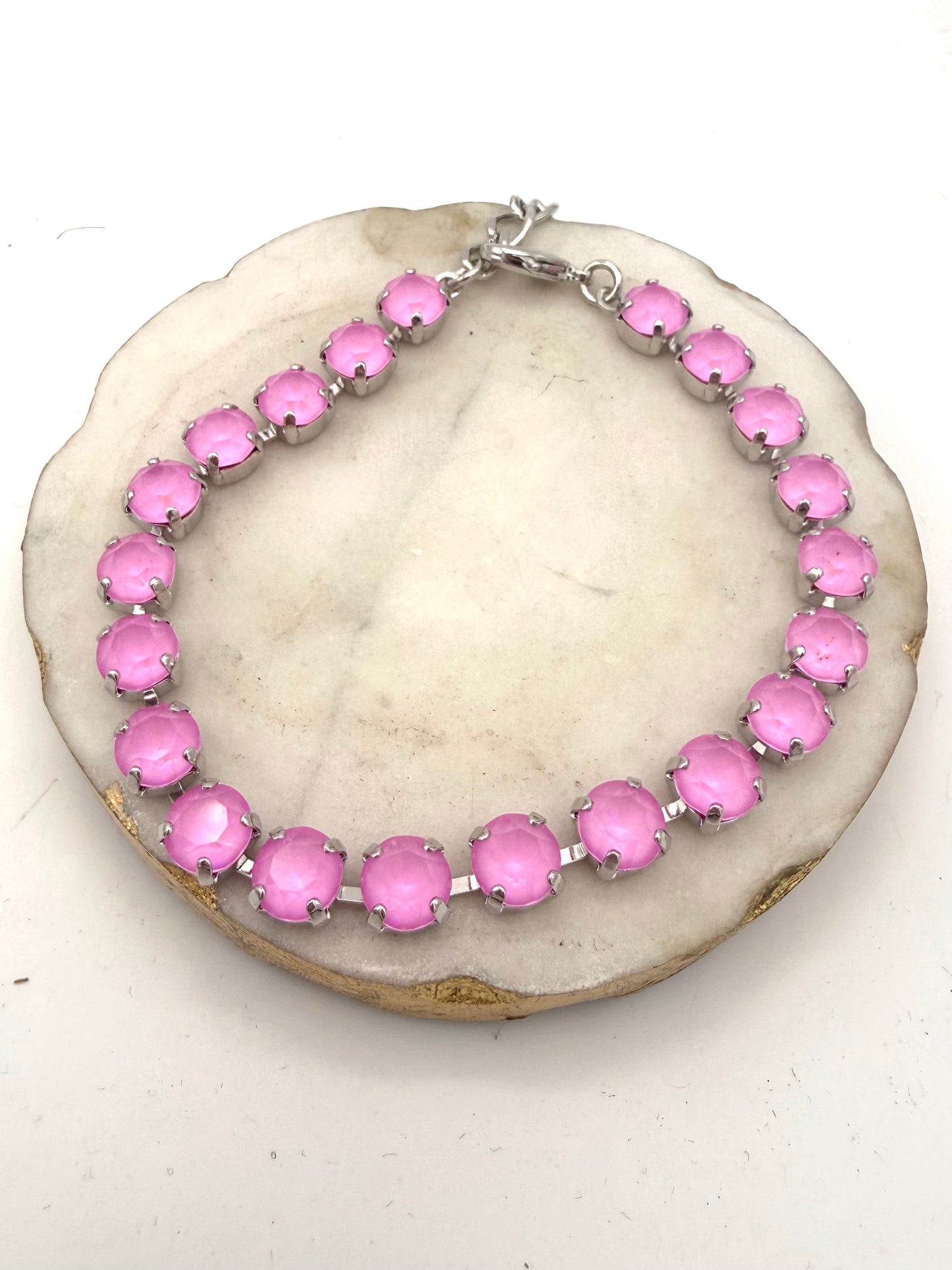 Tennis-style anklet with bubblegum pink faceted stones in silver prong settings with lobster clasp closure.