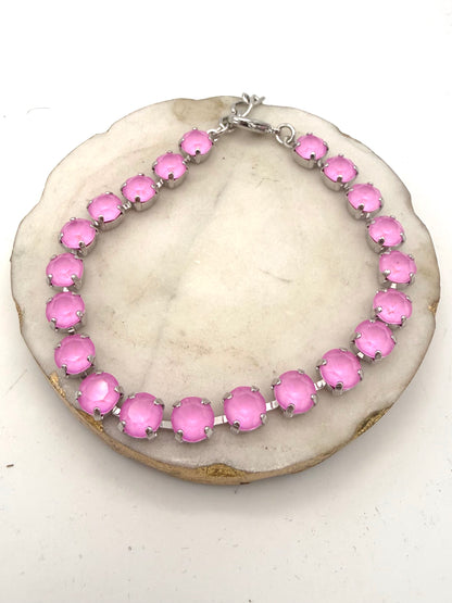 Tennis-style anklet with bubblegum pink faceted stones in silver prong settings with lobster clasp closure.