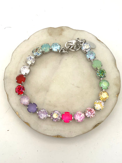Rainbow multicolor crystal tennis bracelet in silver prong settings with lobster clasp and extender chain.