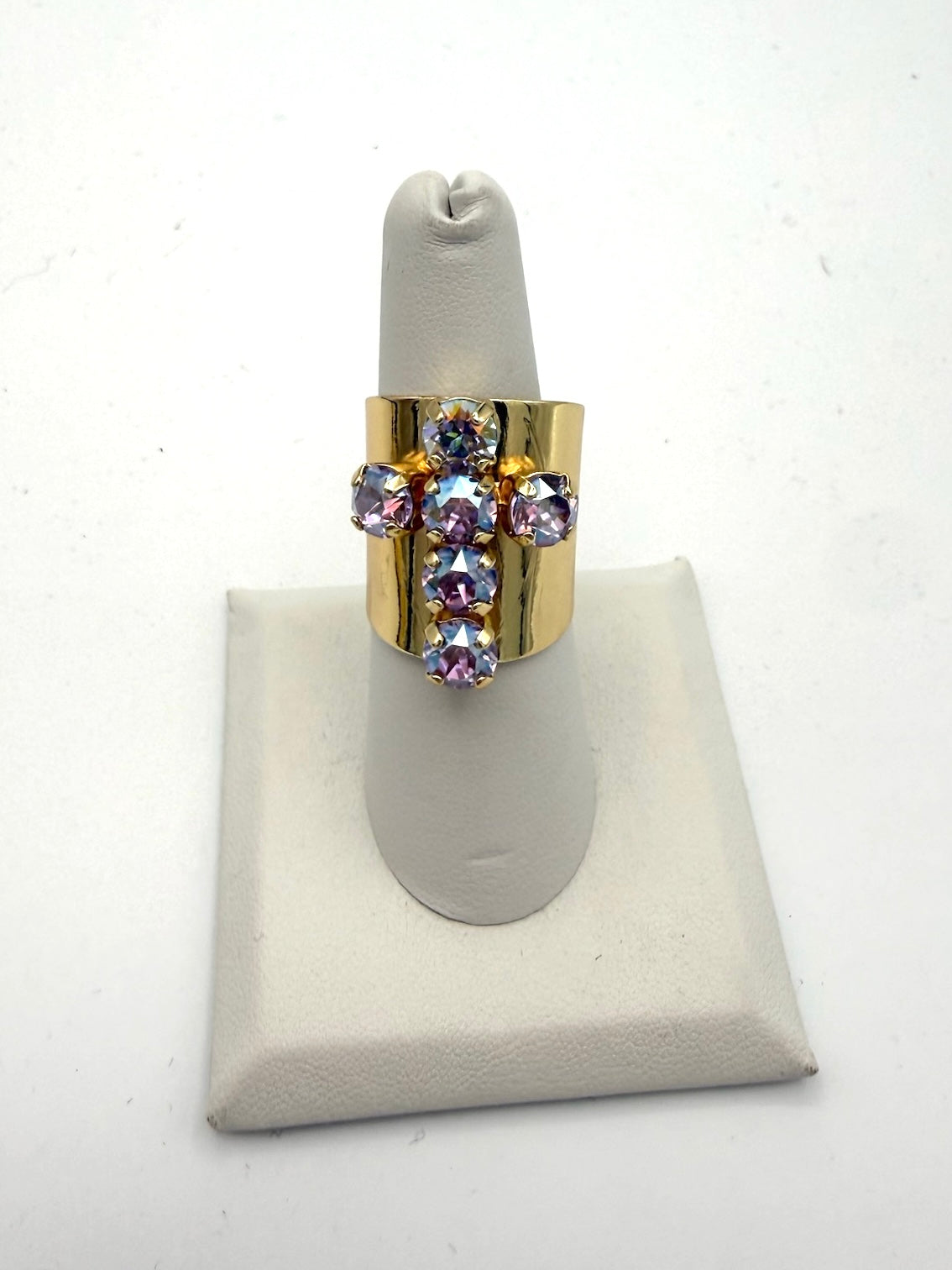 AF Designs gold wide-band ring with lavender and iridescent crystal cross motif in prong settings.