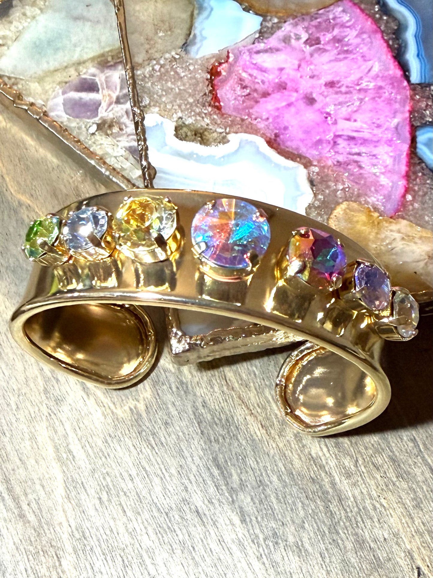 Wide gold cuff bracelet with rainbow multicolor gemstones including iridescent center stone by AF Designs
