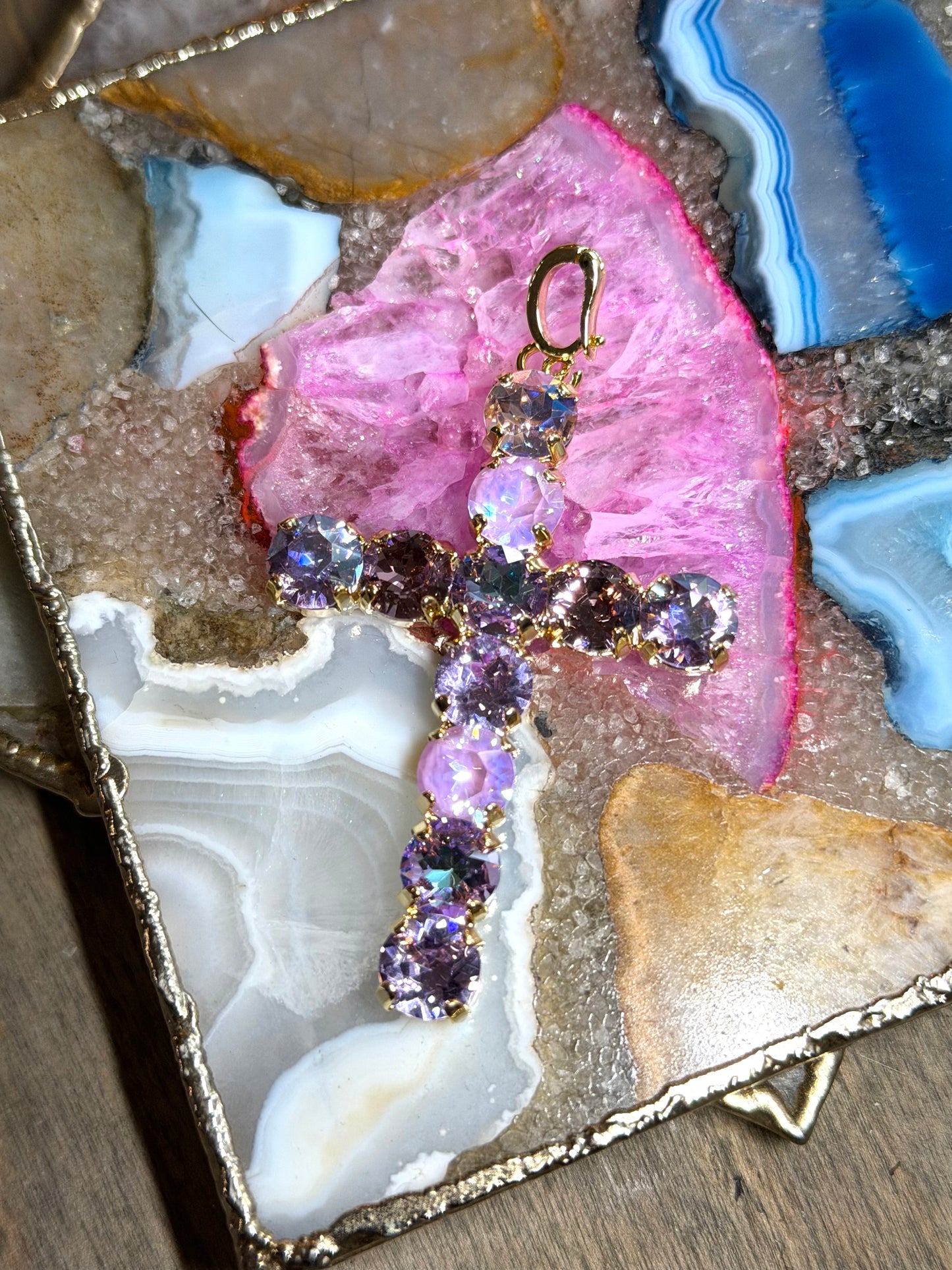 Large crystal cross charm pendant in mixed purple lavender tones with gold prong settings and iridescent finish