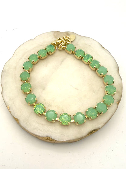 Gold tennis anklet with continuous round mint and peridot green crystals in prong settings with lobster clasp