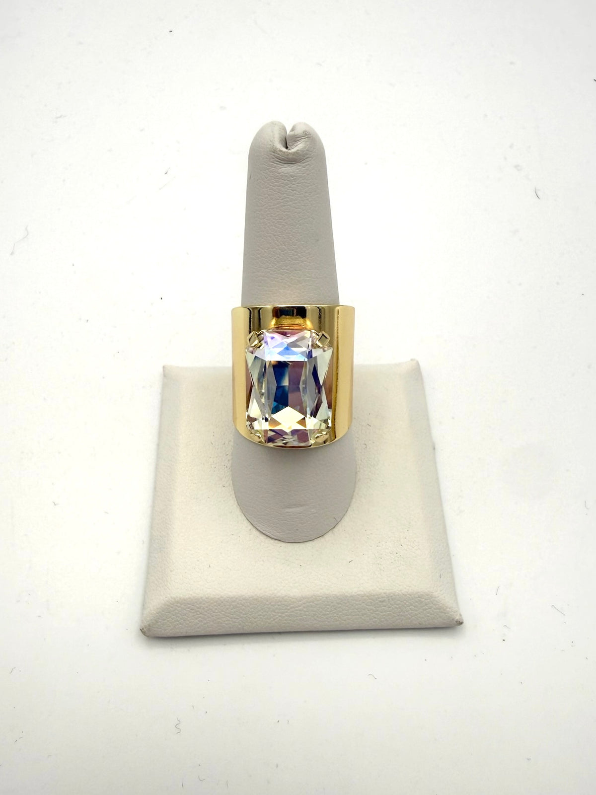 Bold gold-tone wide band ring with large iridescent AB crystal emerald-cut stone, statement cocktail style