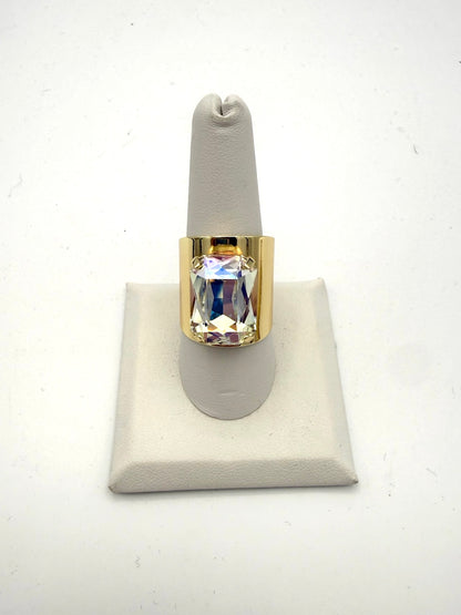 Bold gold-tone wide band ring with large iridescent AB crystal emerald-cut stone, statement cocktail style