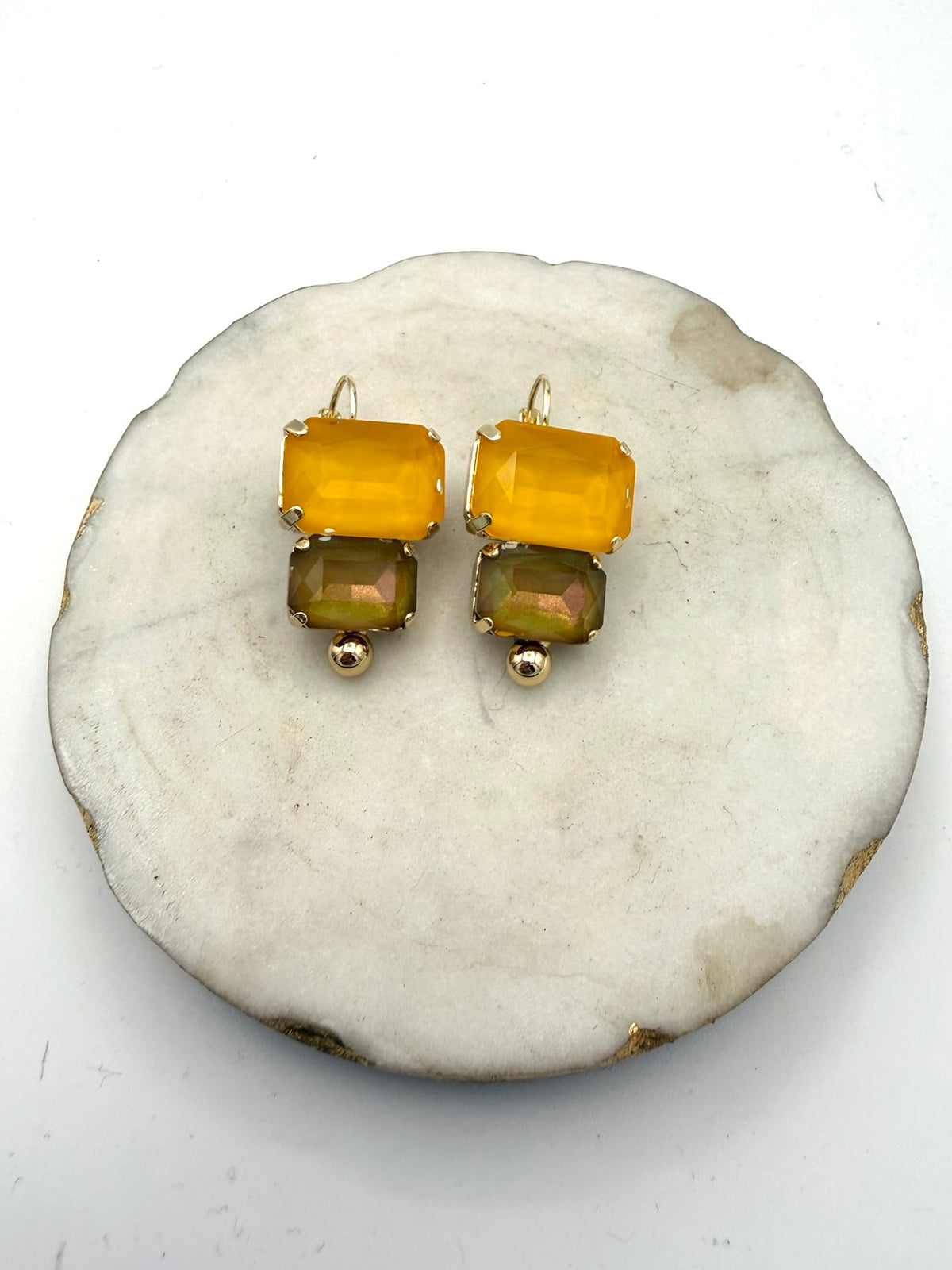 Gold drop earrings with yellow amber top stone, iridescent olive green bottom stone, and gold ball accent