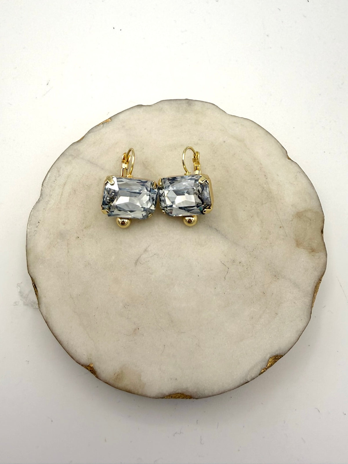 AF Designs Ice Queen gold leverback earrings with large icy blue-gray rectangular cushion-cut crystals