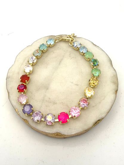 Multicolor rainbow crystal tennis bracelet with gold prong settings and lobster clasp, featuring 20 faceted gemstone-style stones