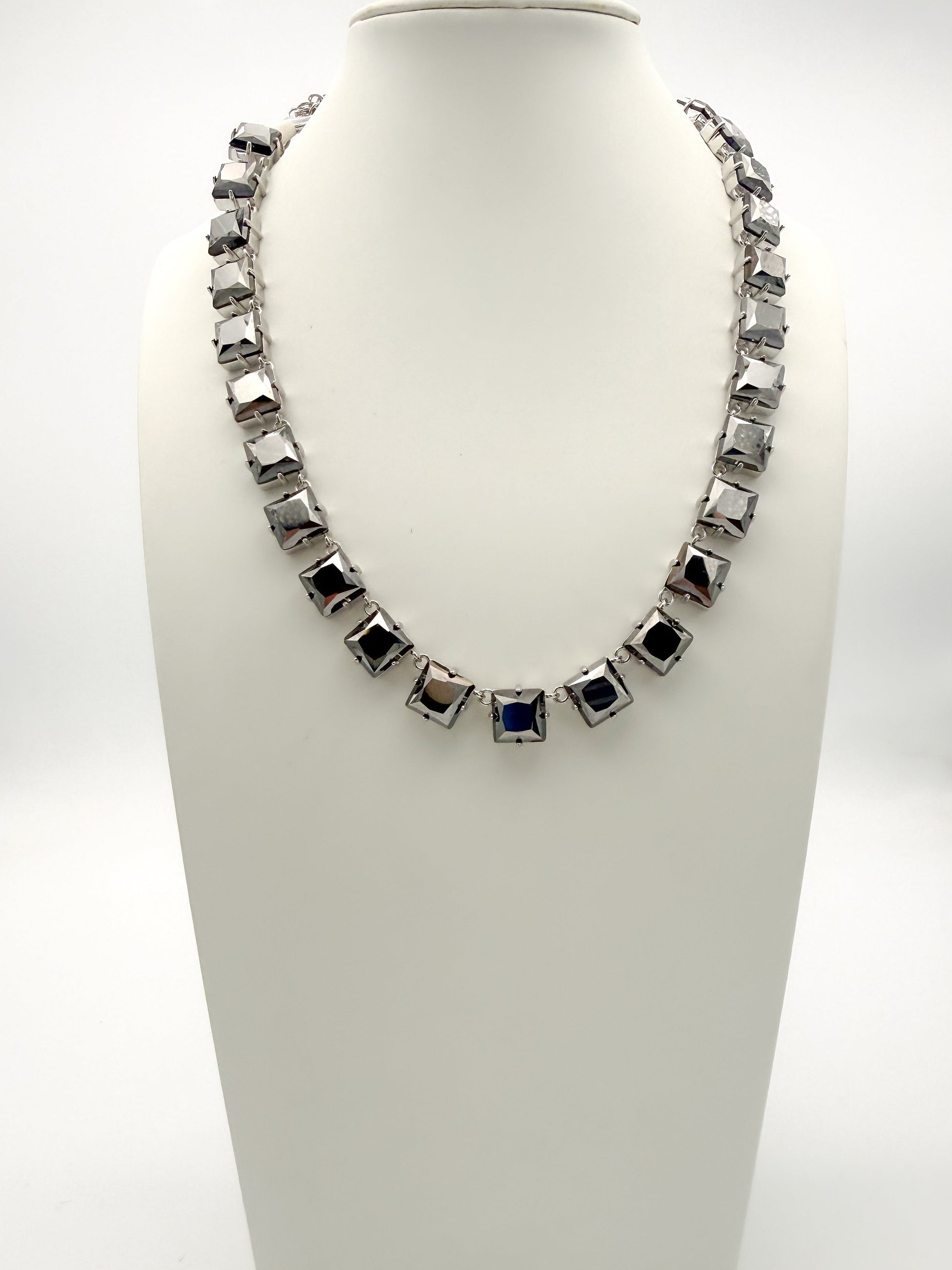 Gunmetal square-link statement collar necklace with color-shifting black and navy cushion-shaped stones.