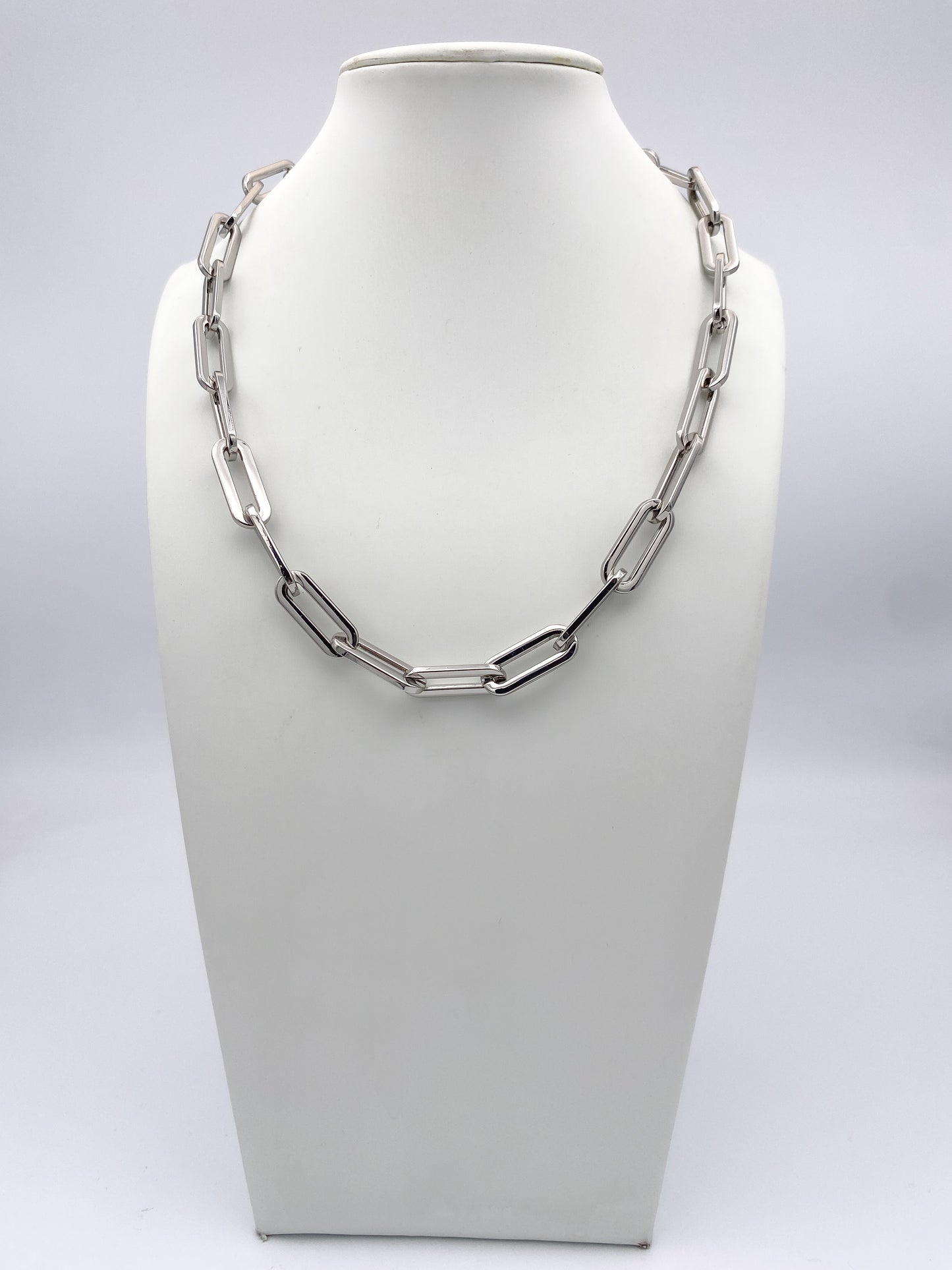 AF Designs silver oversized paperclip chain link necklace displayed on white jewelry bust, collarbone length