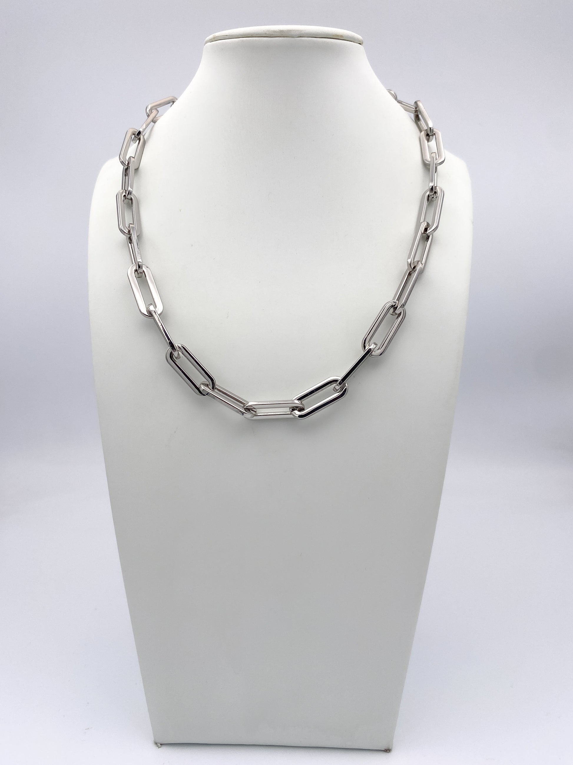 AF Designs silver oversized paperclip chain link necklace displayed on white jewelry bust, collarbone length