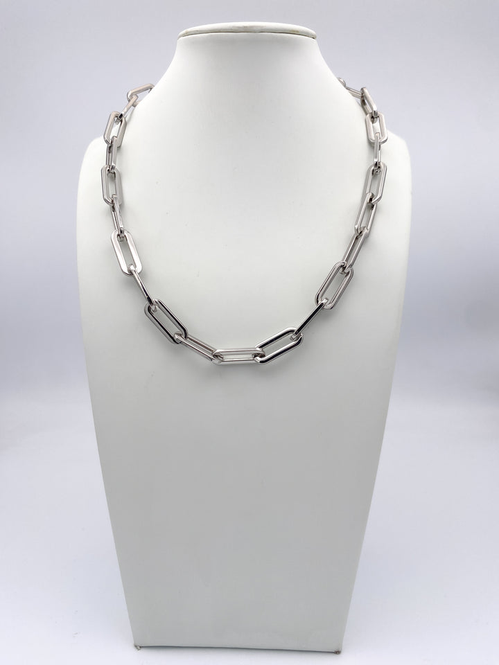 AF Designs silver oversized paperclip chain link necklace displayed on white jewelry bust, collarbone length