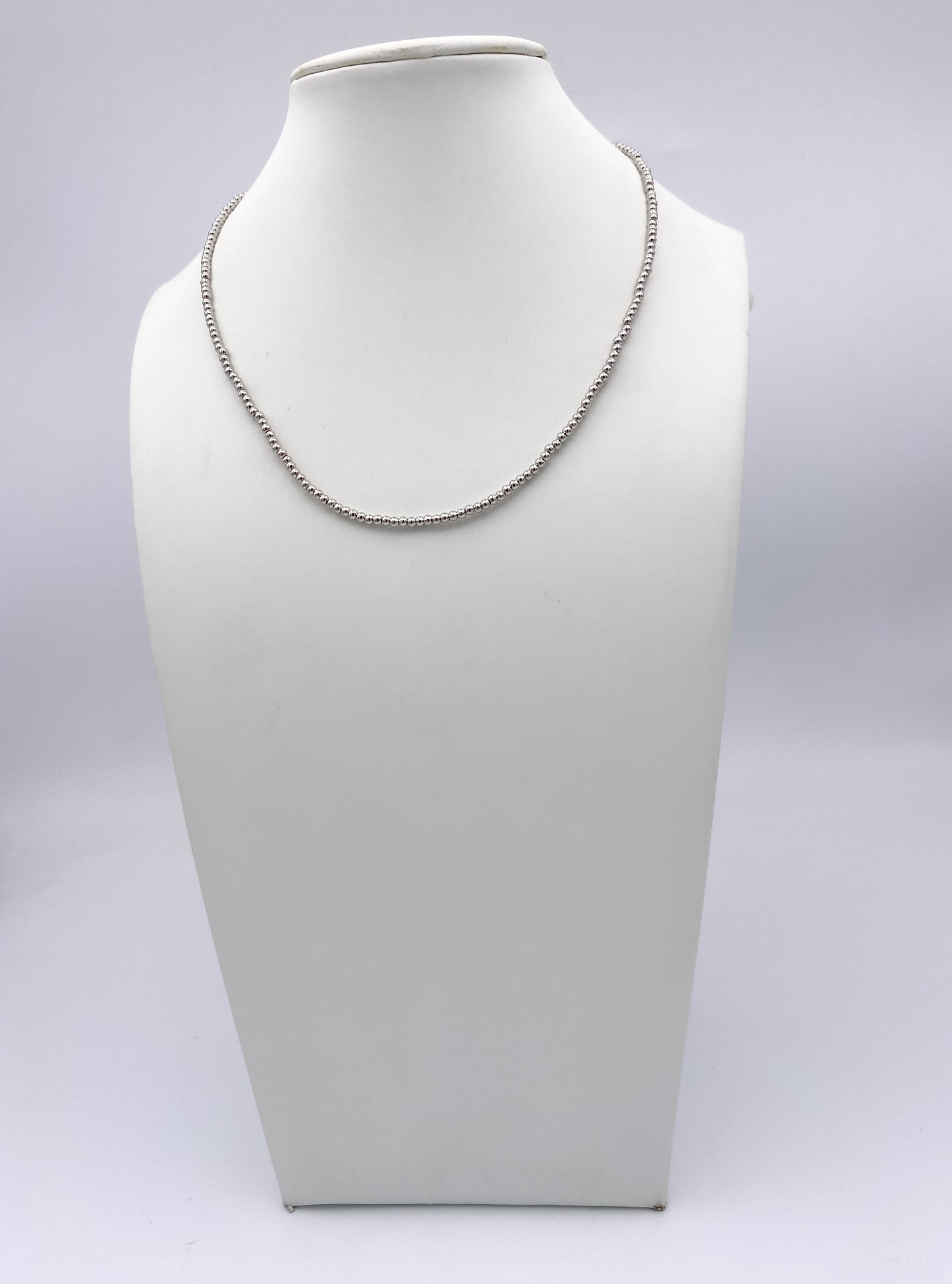 AF Designs Steal My Heart silver beaded necklace with polished spherical beads on white jewelry bust