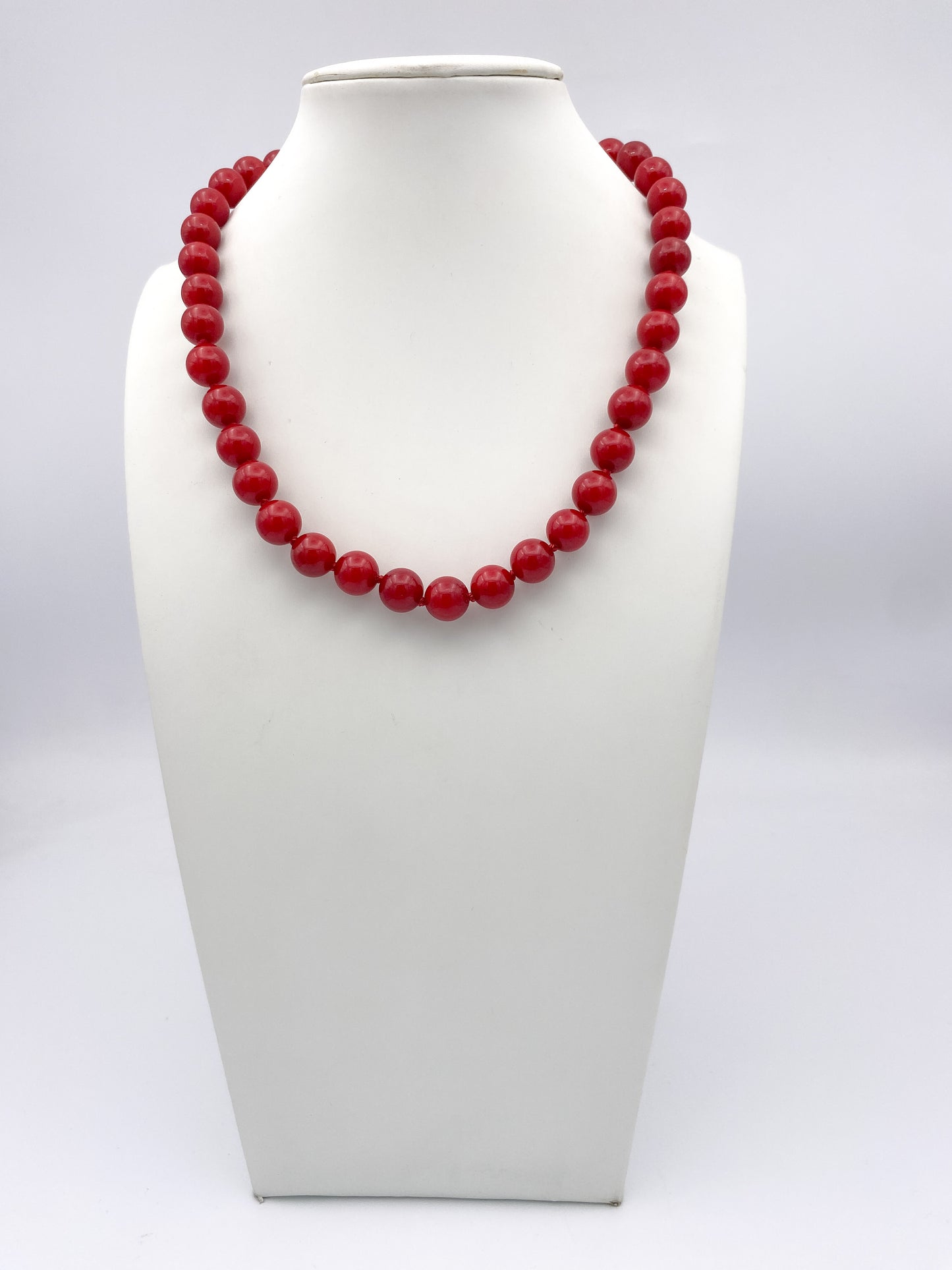 AF Designs Scarlet Romance Necklace: single-strand glossy red round beads, princess length, on white bust form.