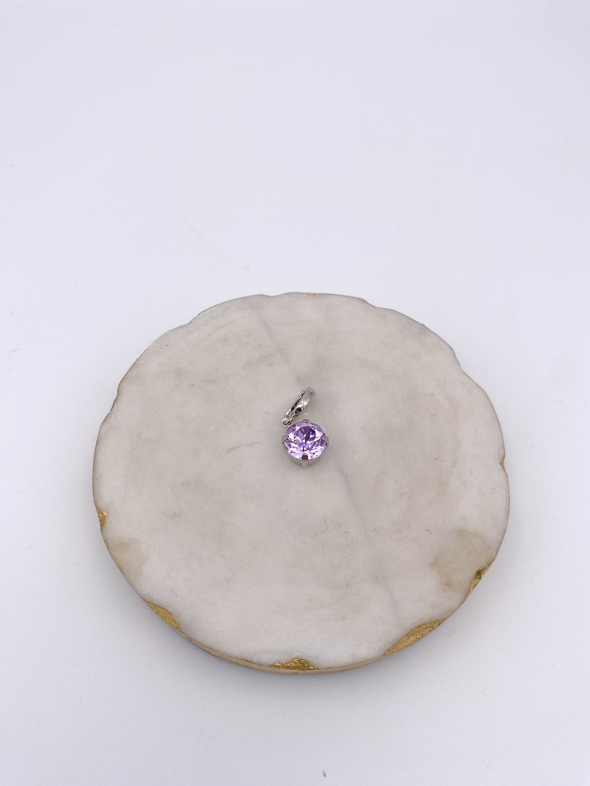 Small round lavender gemstone charm pendant with silver prong setting and bail, ideal for necklaces or bracelets.