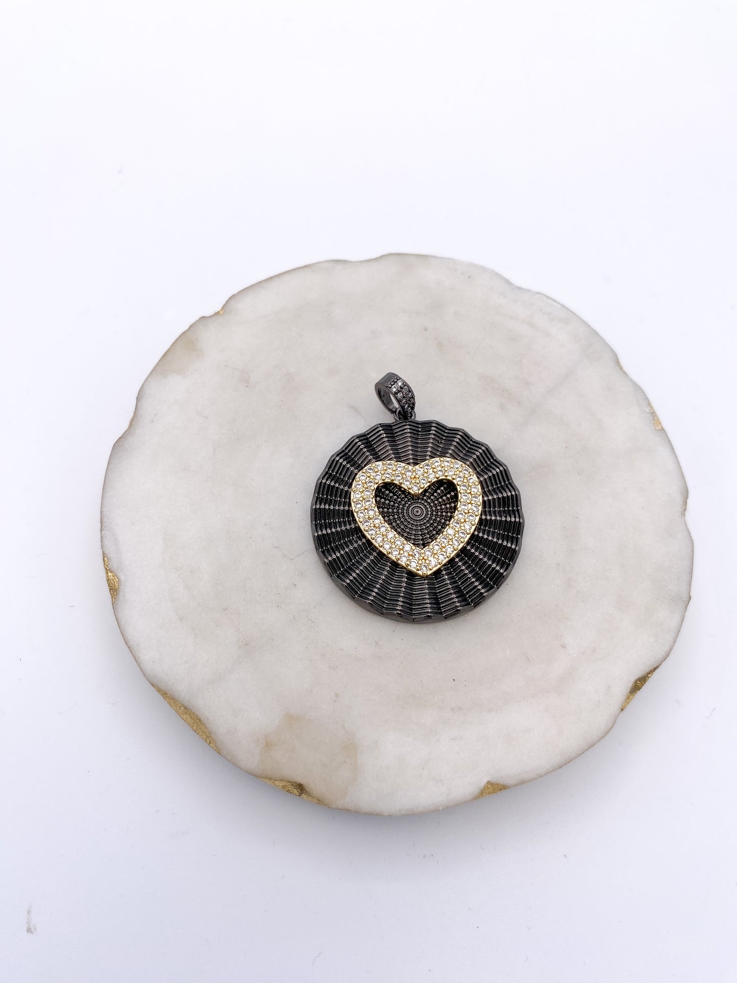 Gunmetal black circular pendant with gold pavé crystal heart centerpiece and crystal-studded bail by AF Designs