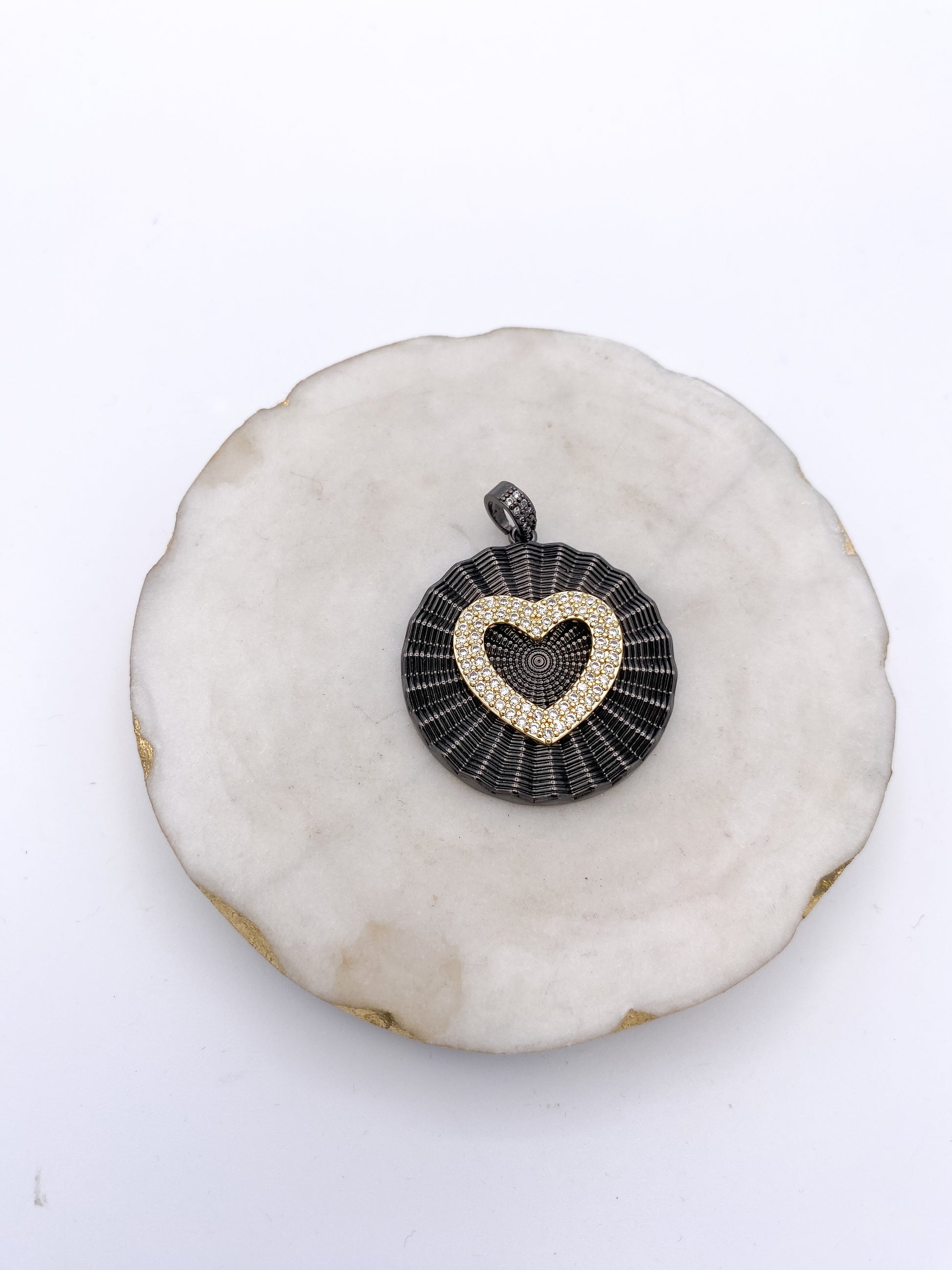 Gunmetal black circular pendant with gold pavé crystal heart centerpiece and crystal-studded bail by AF Designs