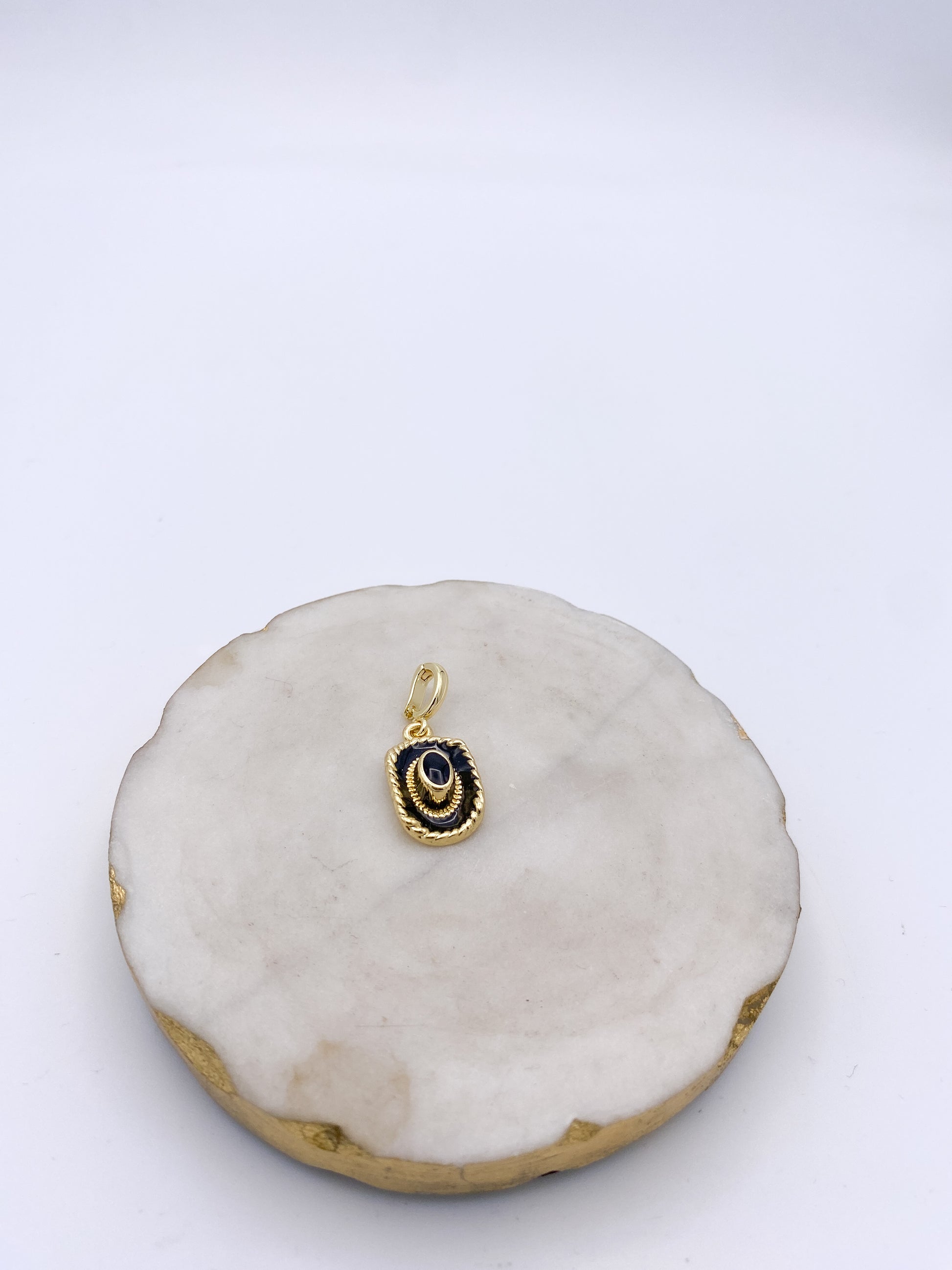 Gold-tone cowboy hat charm pendant with navy enamel and rope border detail by AF Designs