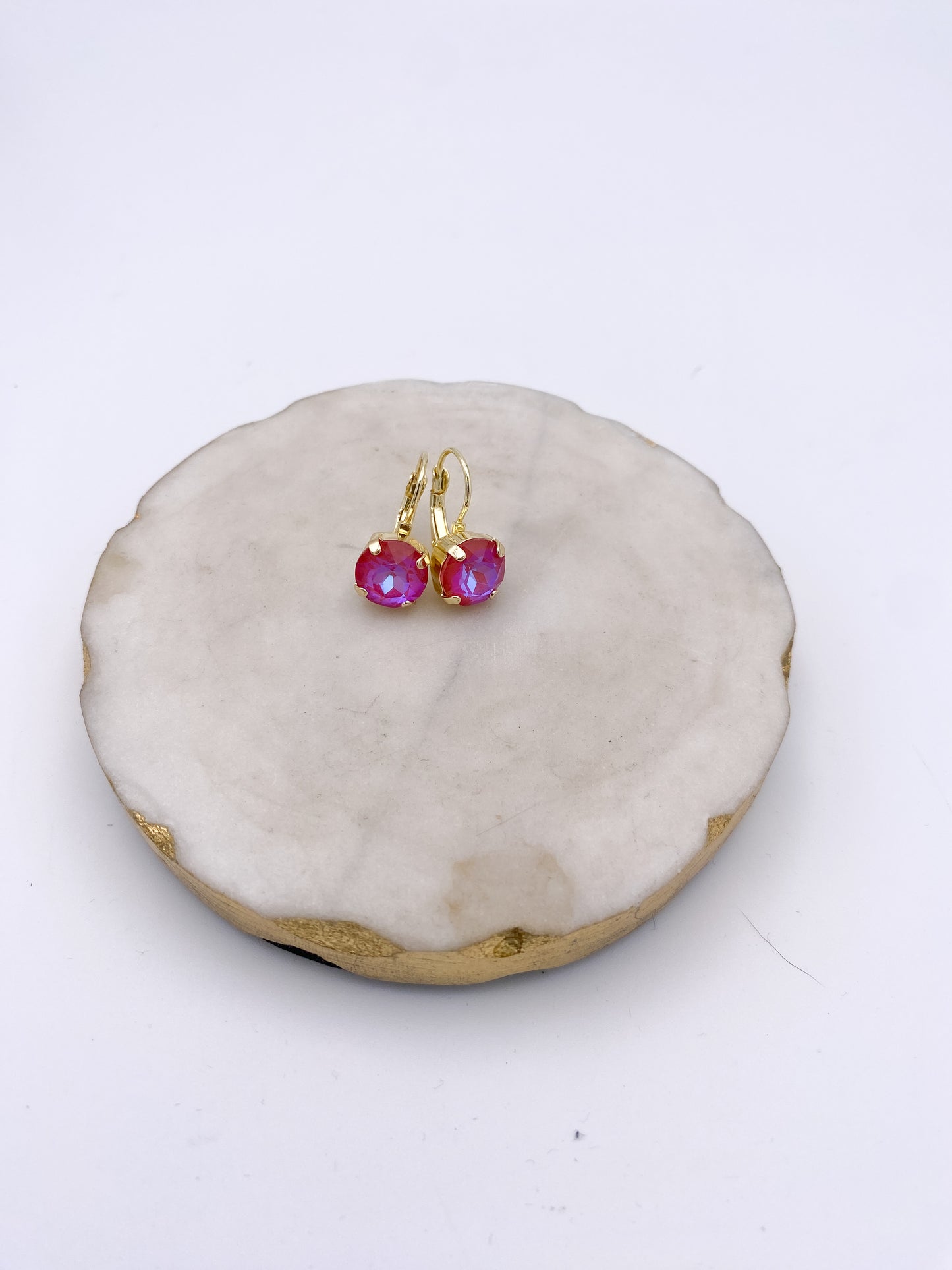 Gold lever-back drop earrings with iridescent raspberry pink faceted crystal stones by AF Designs.