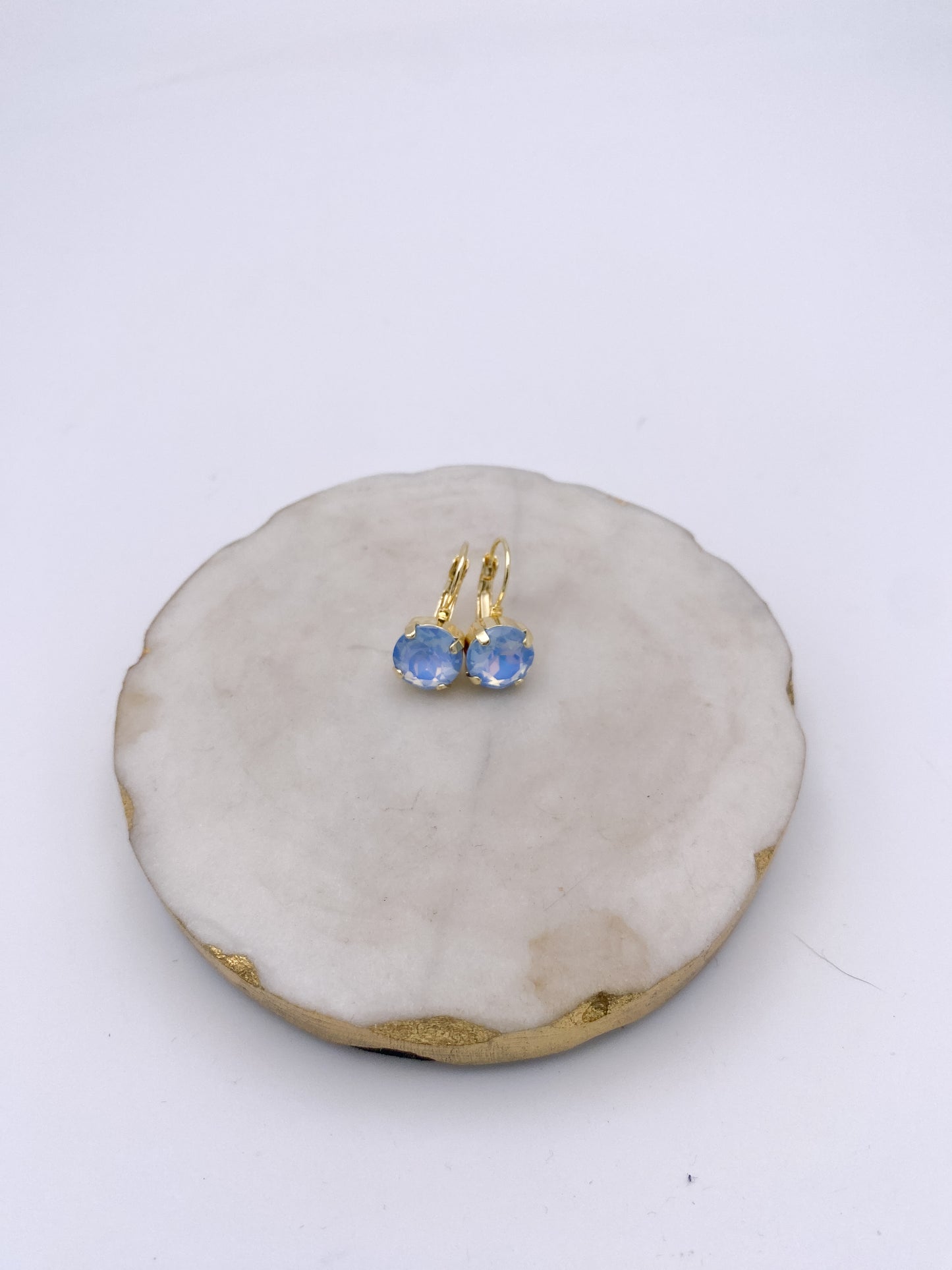 Gold lever-back drop earrings with round opalescent bluebell crystal stones in four-prong settings by AF Designs.