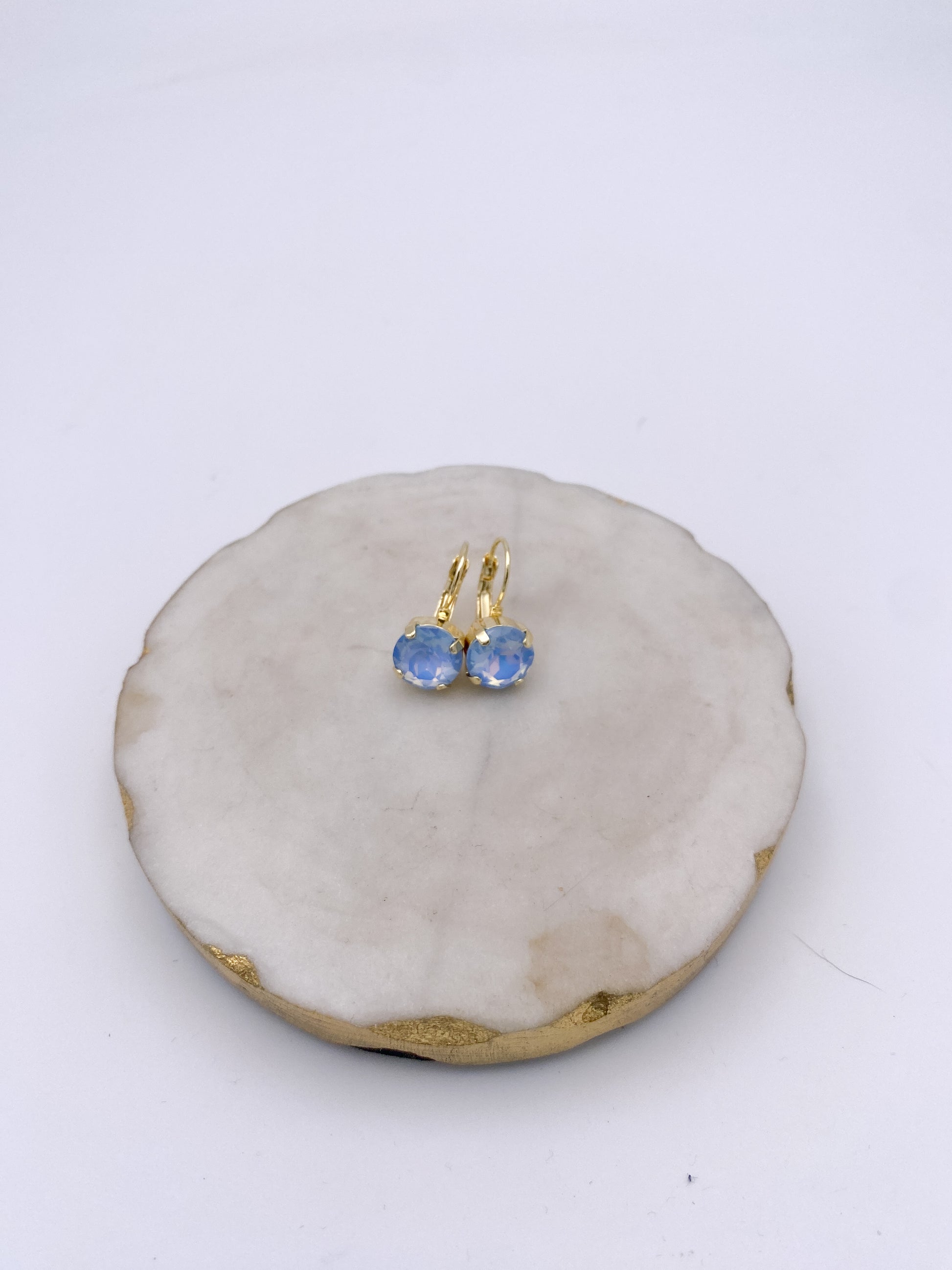 Gold lever-back drop earrings with round opalescent bluebell crystal stones in four-prong settings by AF Designs.