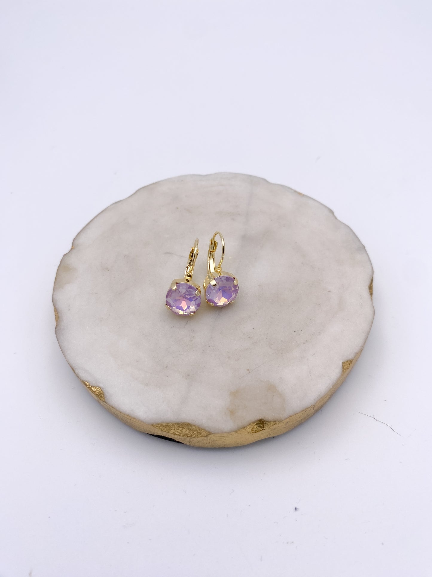 Gold lever-back drop earrings with faceted iridescent violet crystal stones by AF Designs
