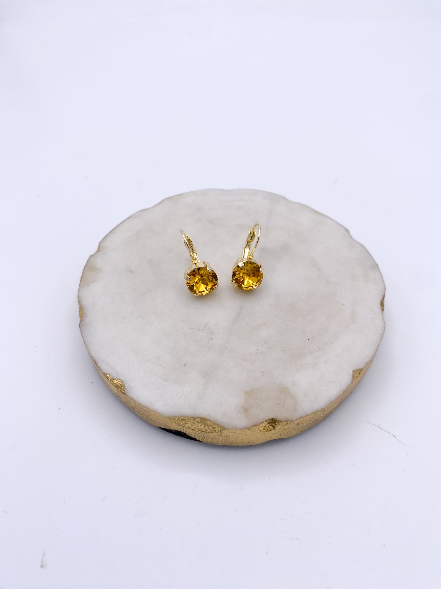 Gold lever-back drop earrings with faceted marigold yellow round gemstone crystals in prong settings