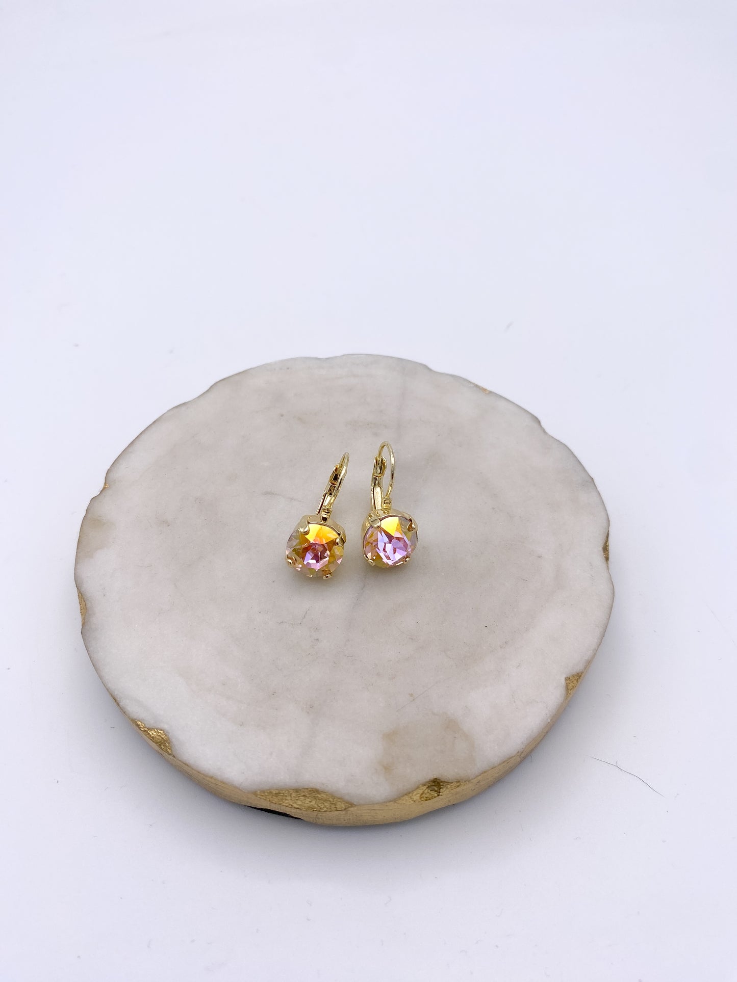 Gold lever-back drop earrings with faceted blush pink iridescent crystal stones in prong settings